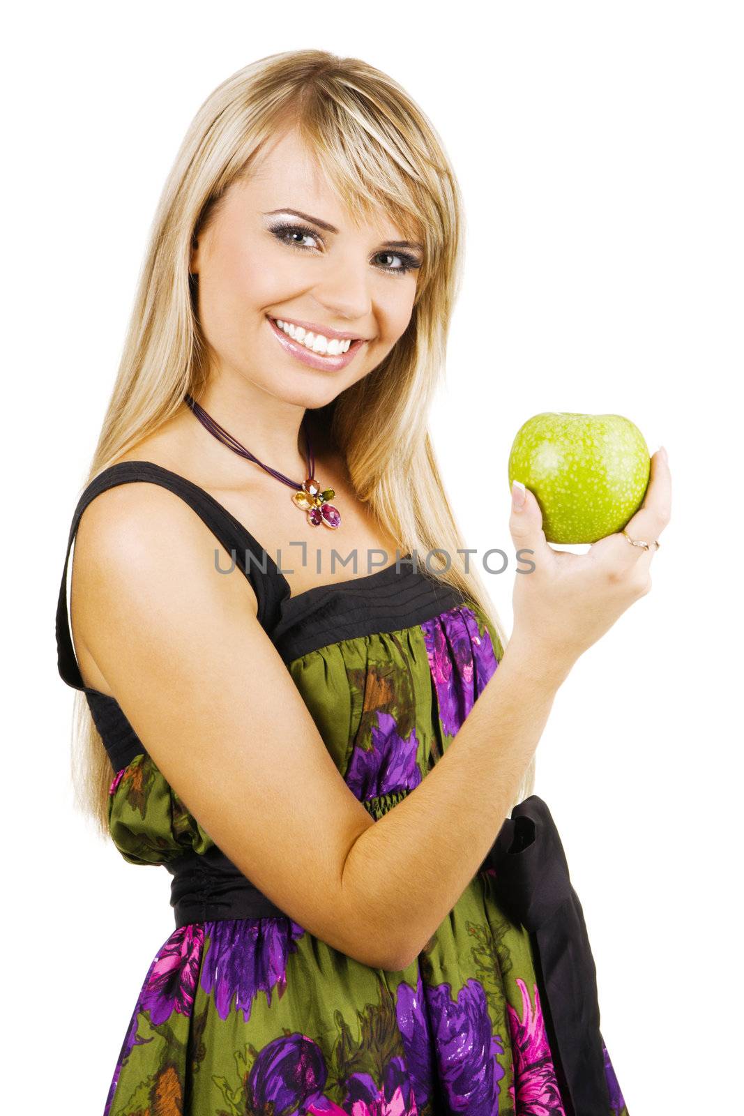 Cheerful young woman holding a fresh freen apple, white background