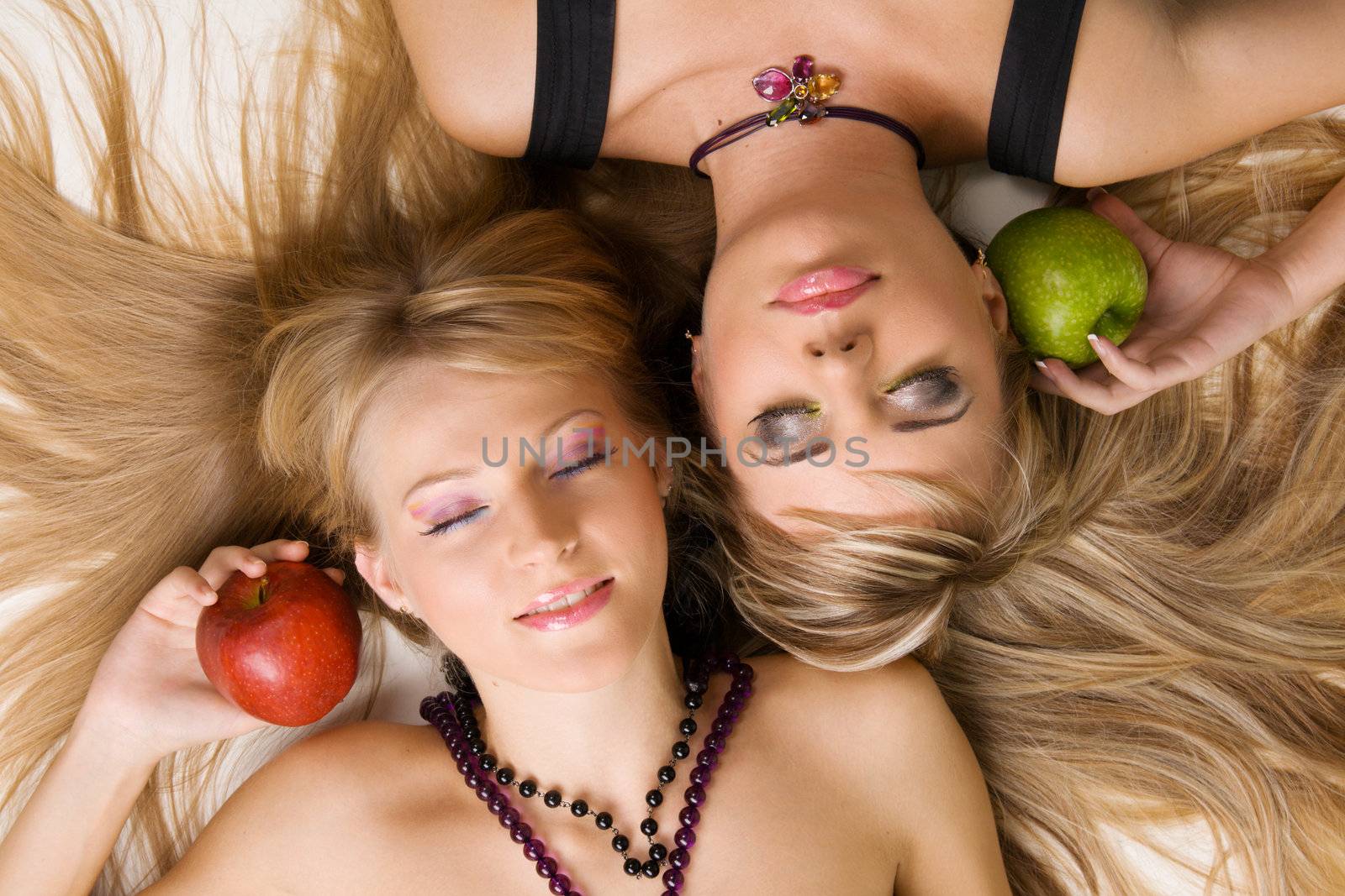 Two cheerful beautiful girls studio portrait