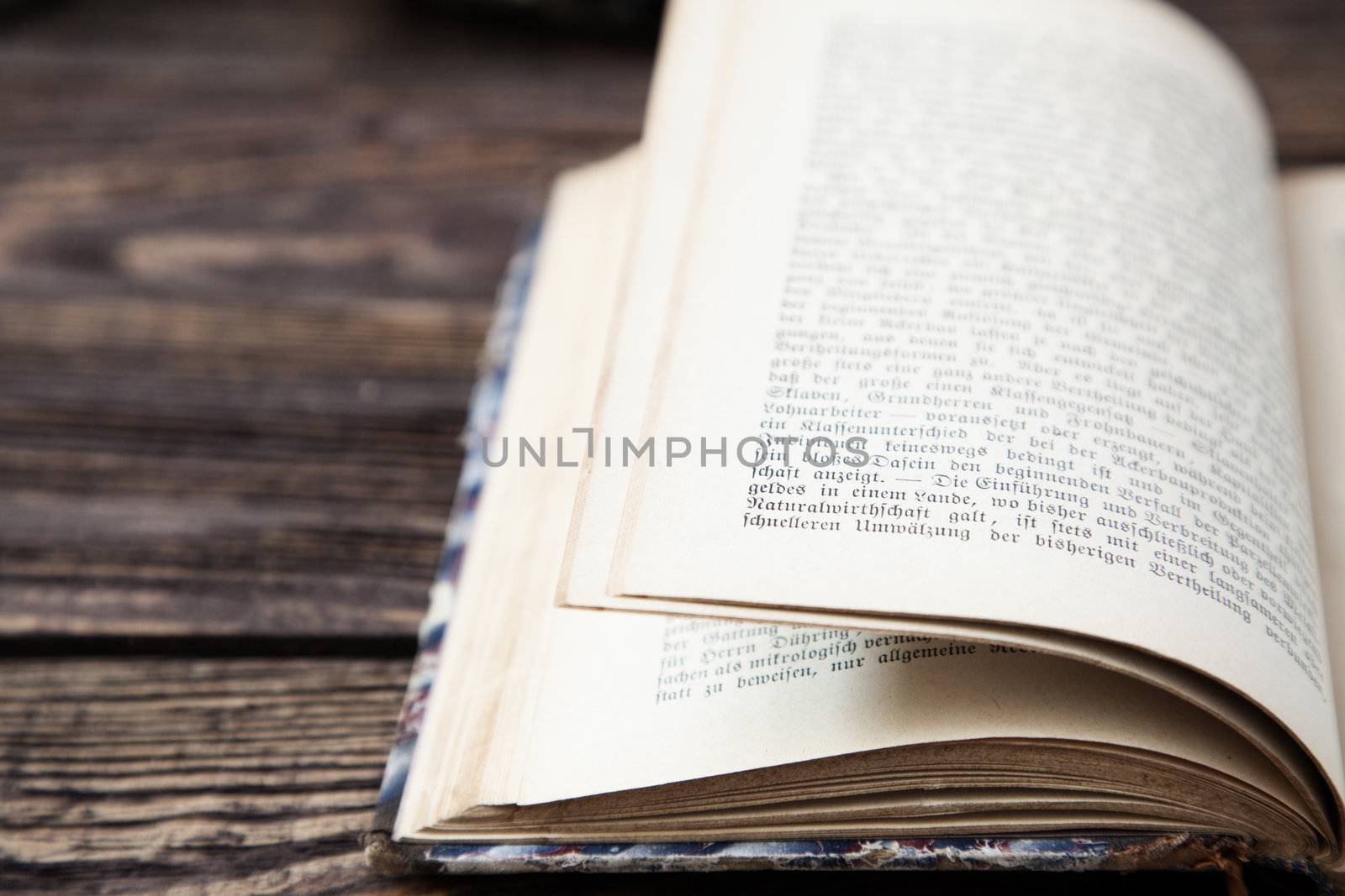 Aged open book on wooden table