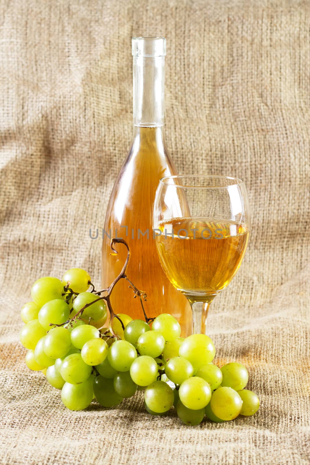 Wine and grapes on vintage background, studio photo