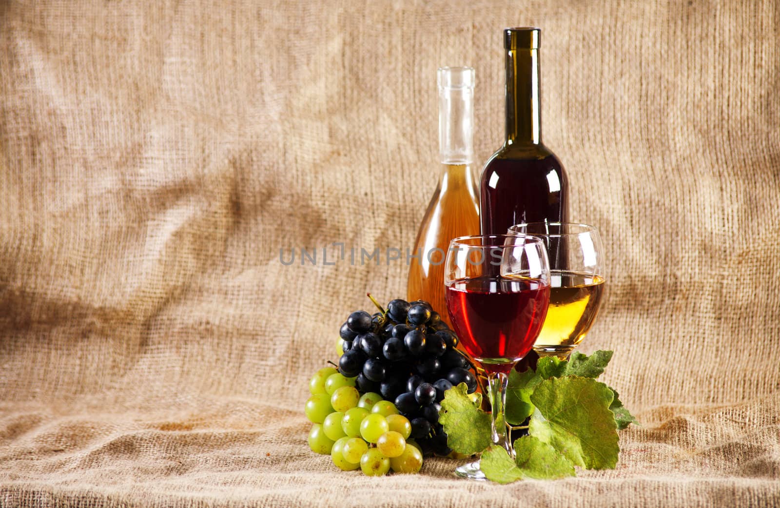 Wine and grapes on vintage background, studio photo