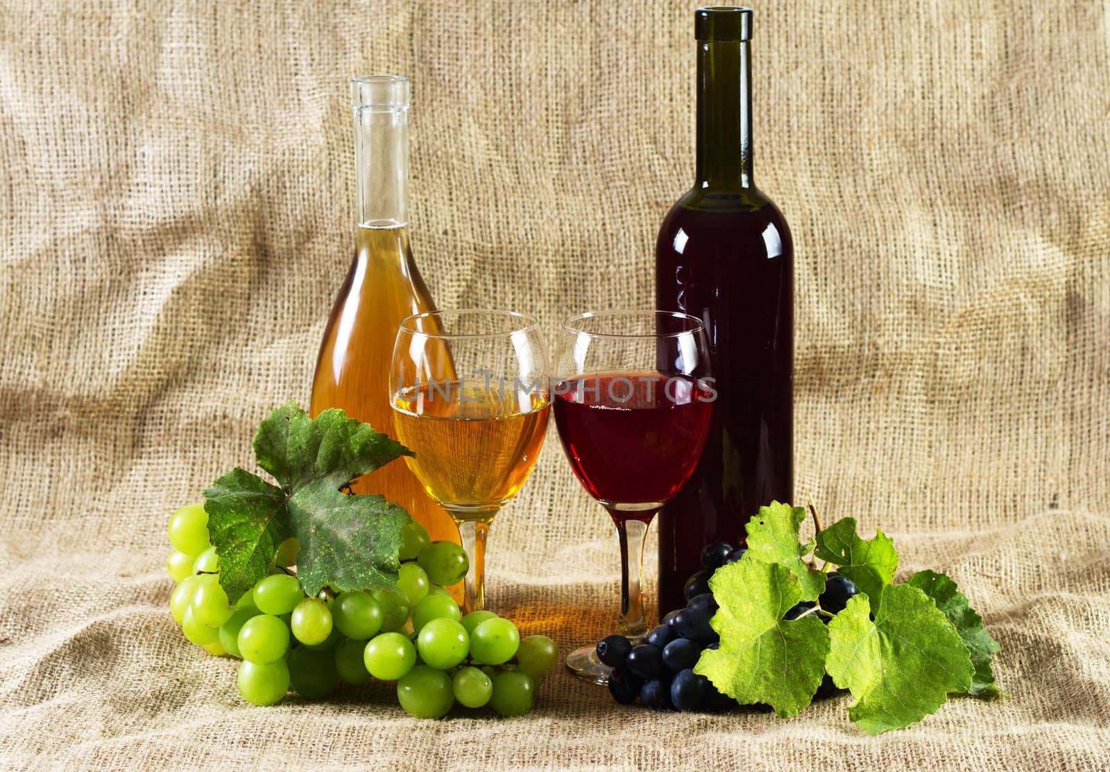 Wine and grapes on vintage background, studio photo