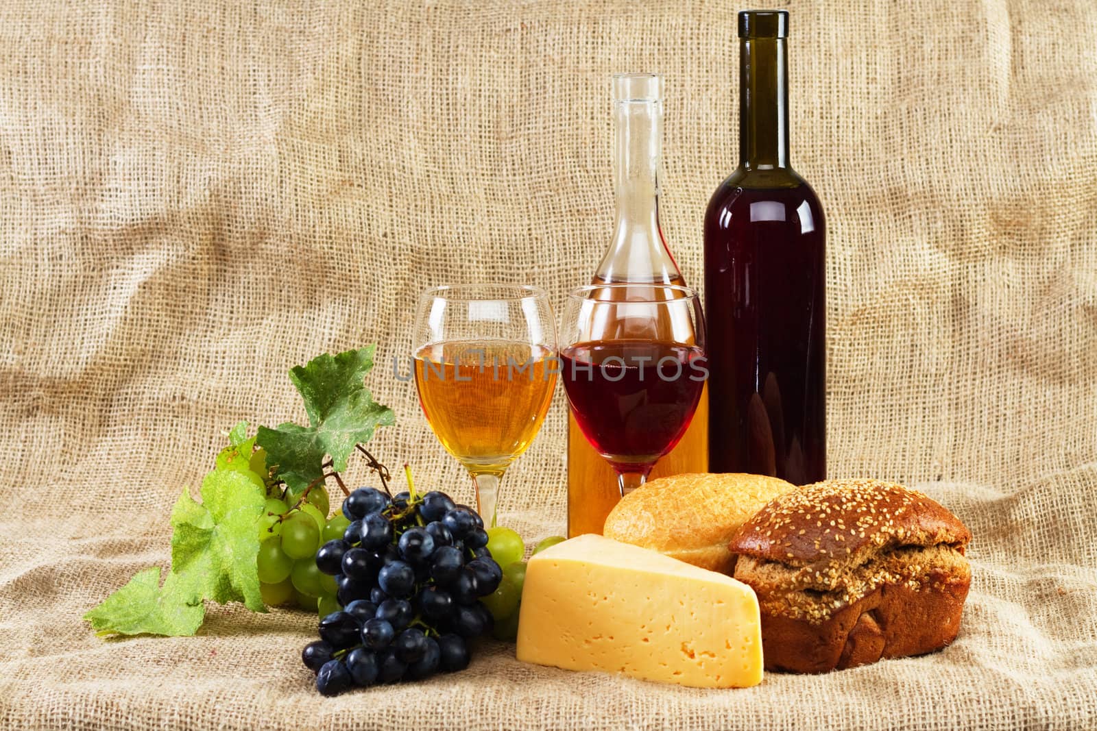 Wine and grapes on vintage background, studio photo