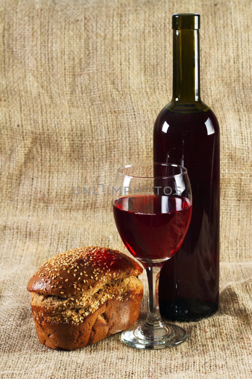 Red wine and grapes on vintage background, studio photo