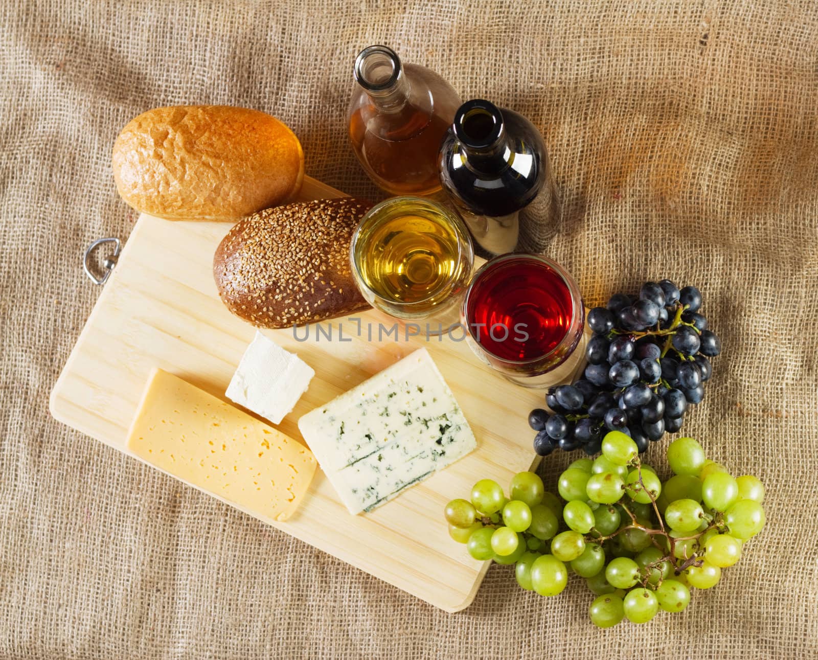 Wine and grapes on vintage background, studio photo