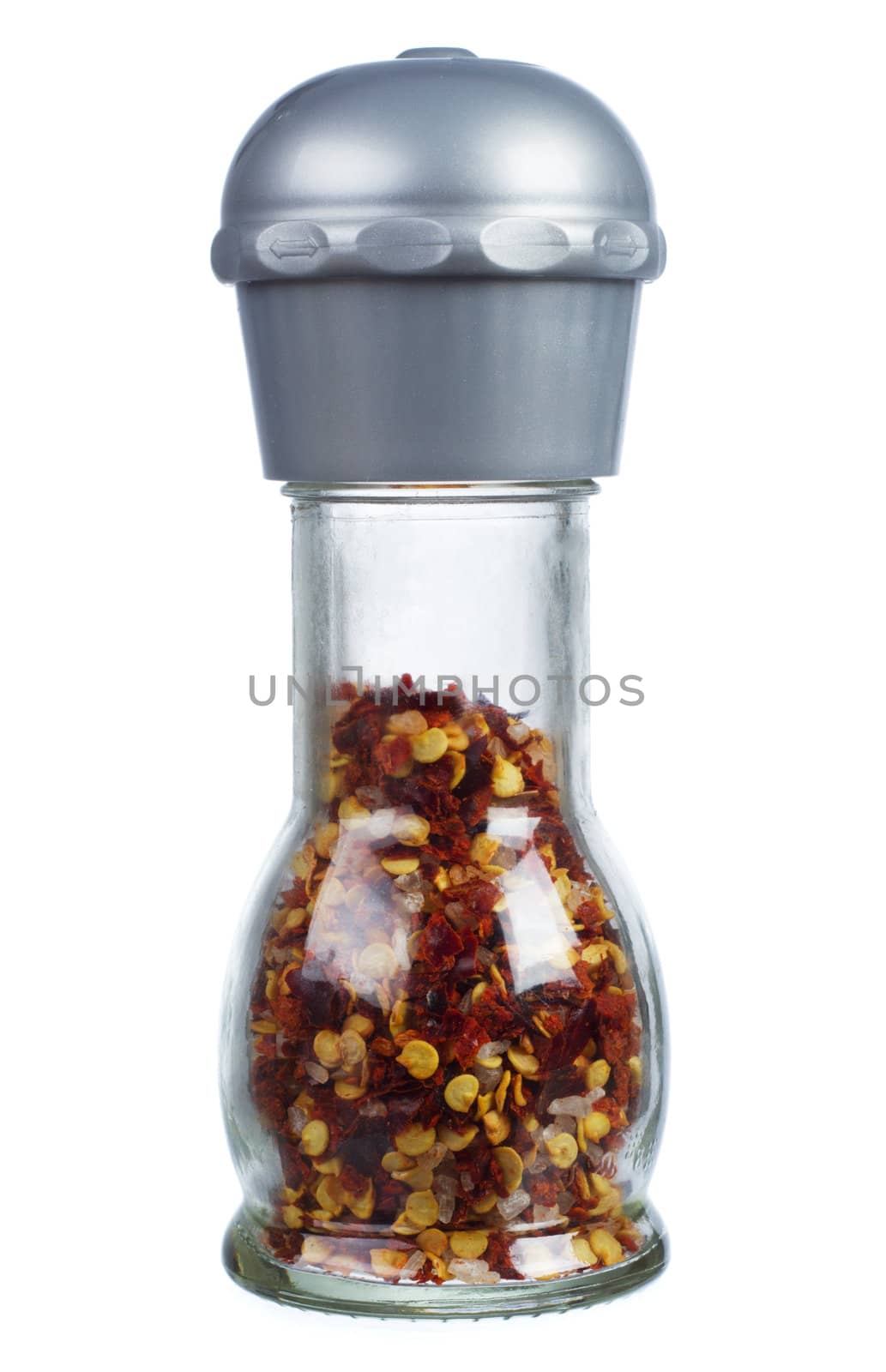 Red chili pepper in a glass container, isolated on white background