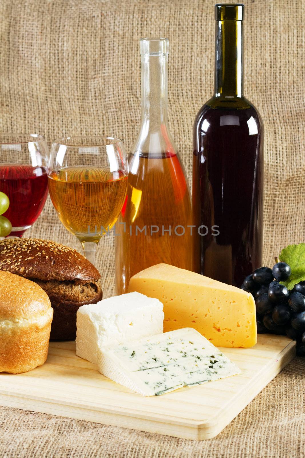 Wine and grapes on vintage background, studio photo