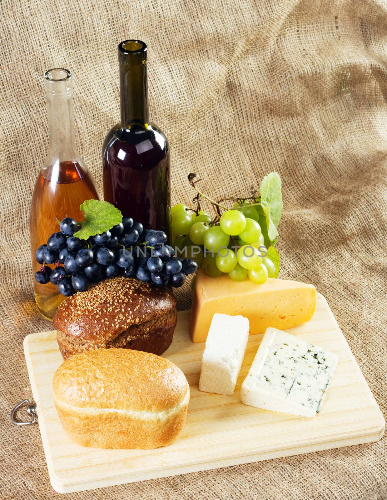 Wine and grapes on vintage background, studio photo