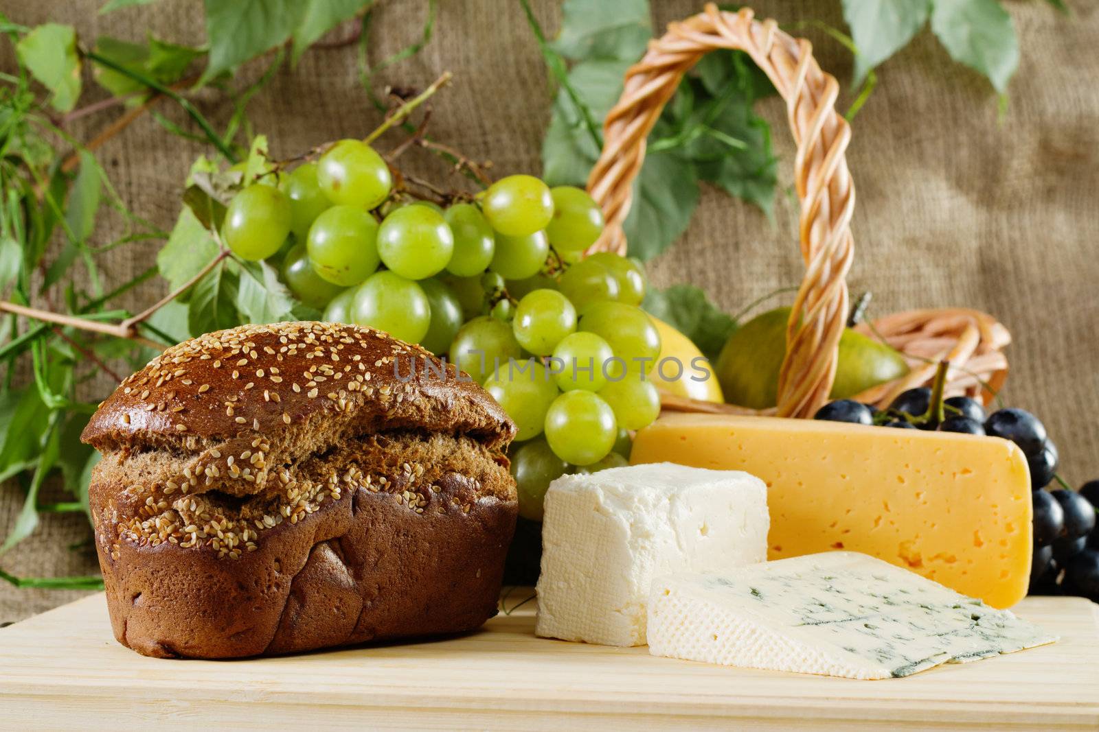 Bread, cheese and grapes still-life