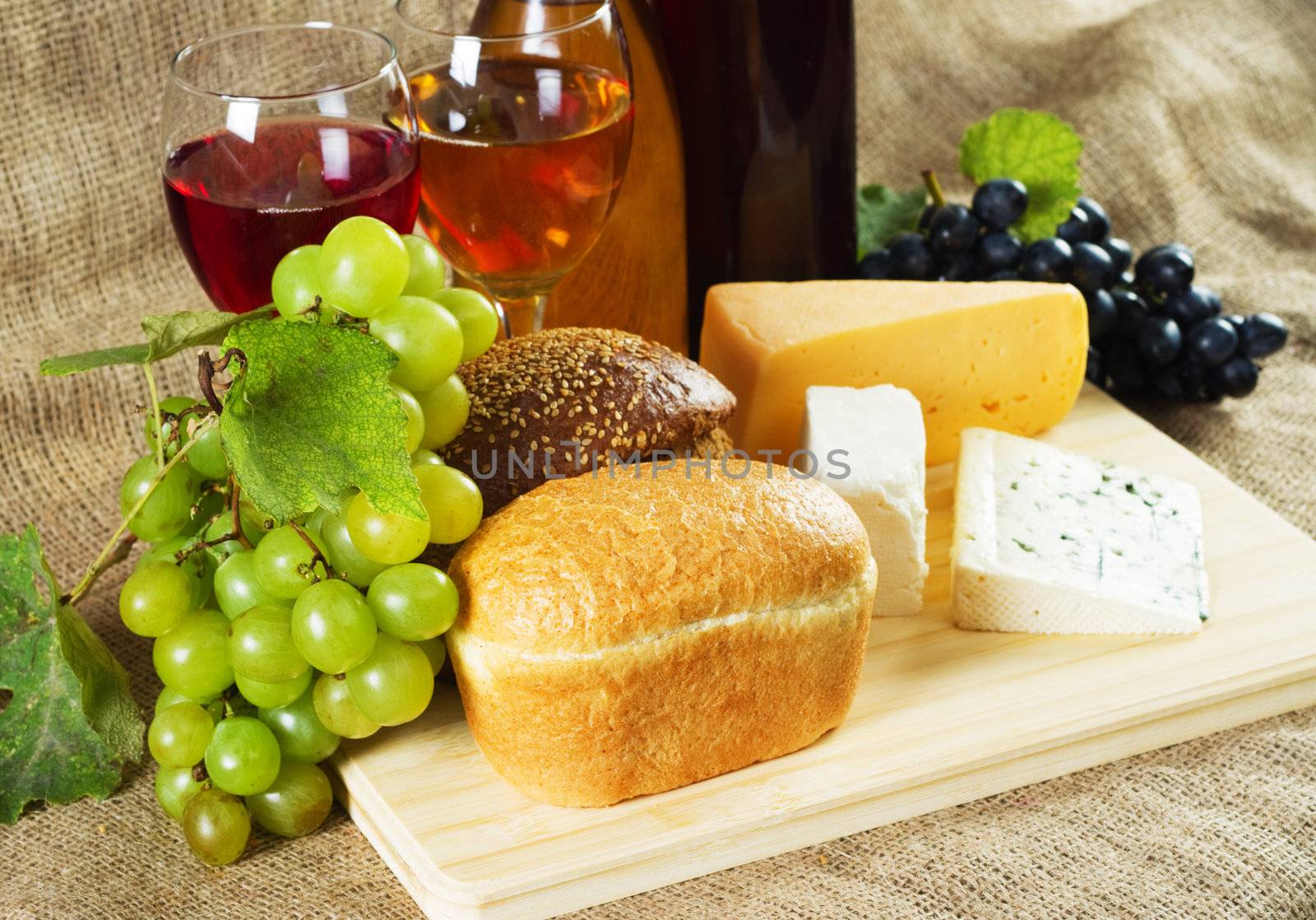 Wine and grapes on vintage background, studio photo