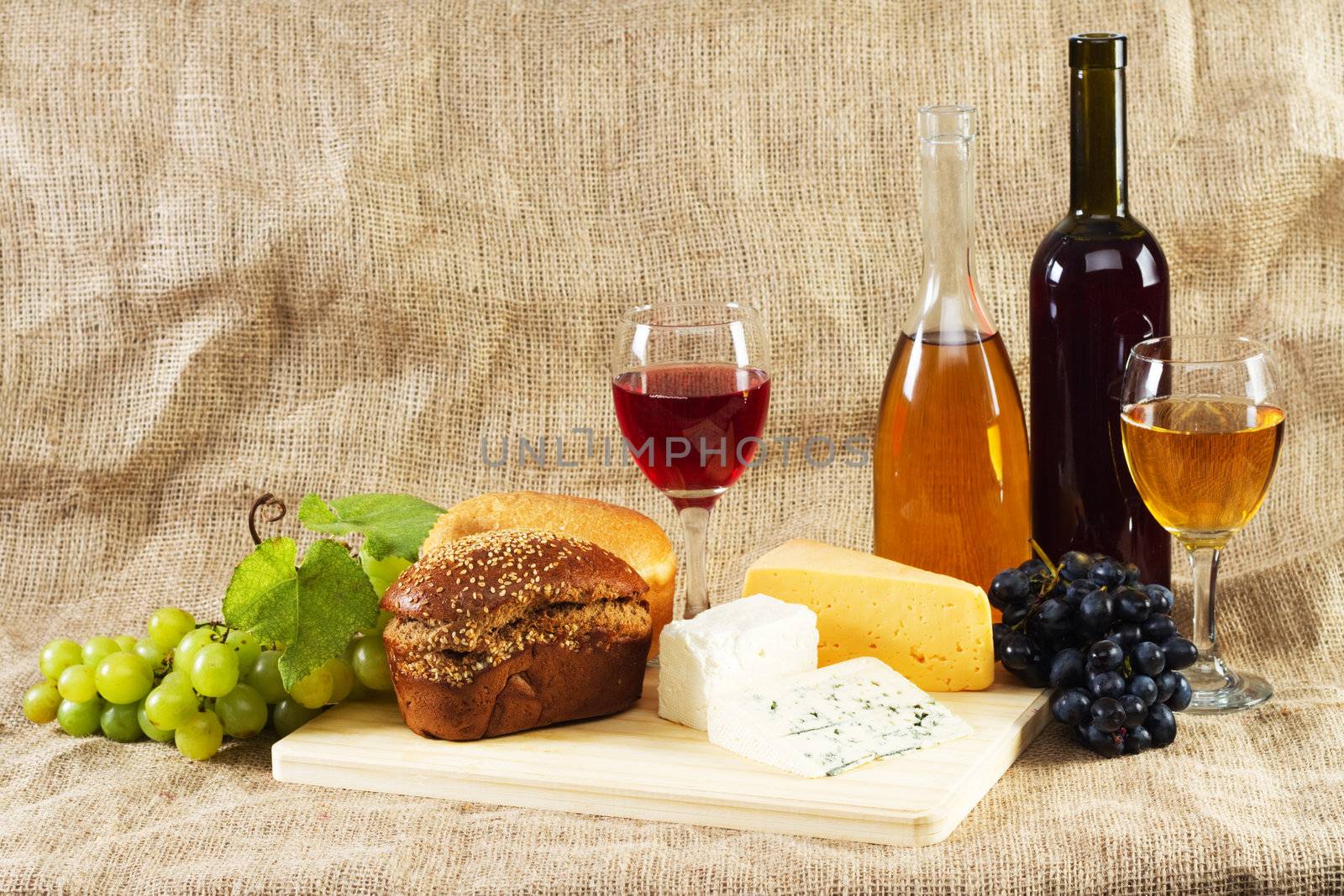 Wine and grapes on vintage background, studio photo