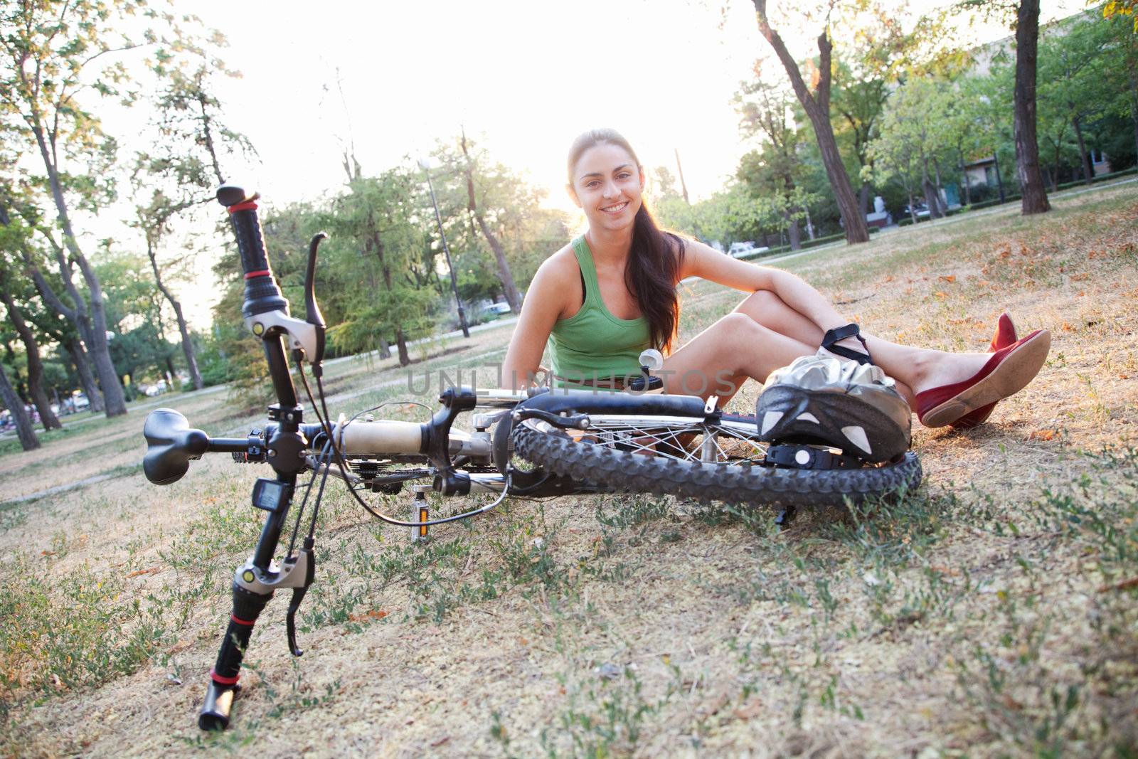 Beautiful young slim woman riding a bicycle