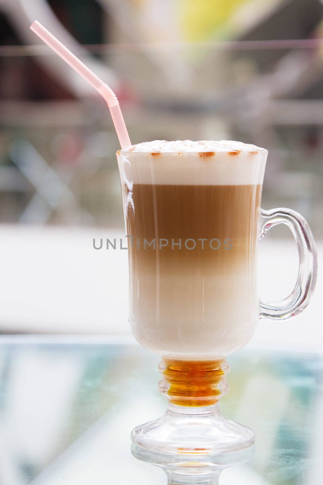 Coffee cup with artistic cream decoration by Gdolgikh