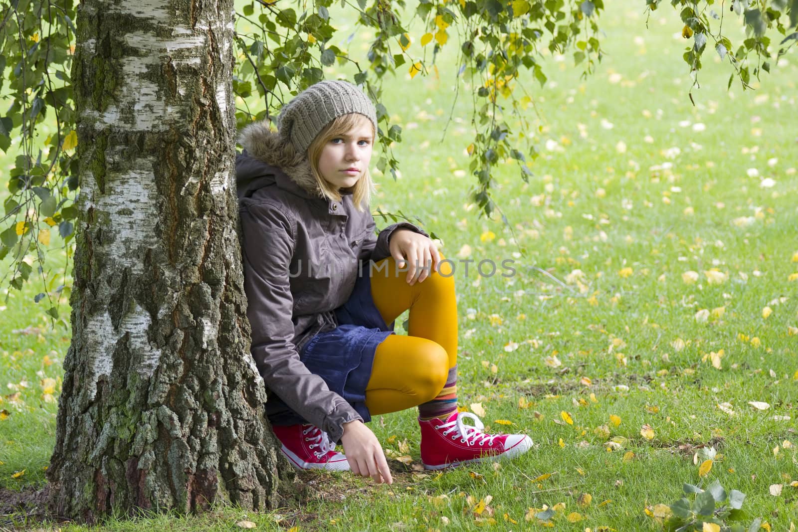 Cute girl in autumn park by miradrozdowski