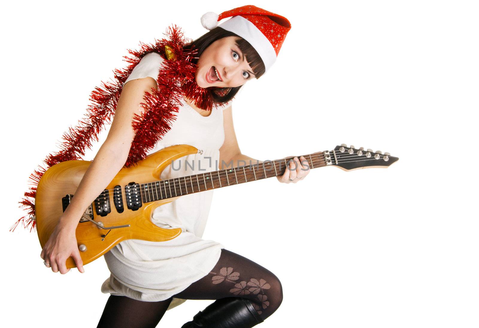 Expressive young woman in Santa's hat playing an electric guitar 