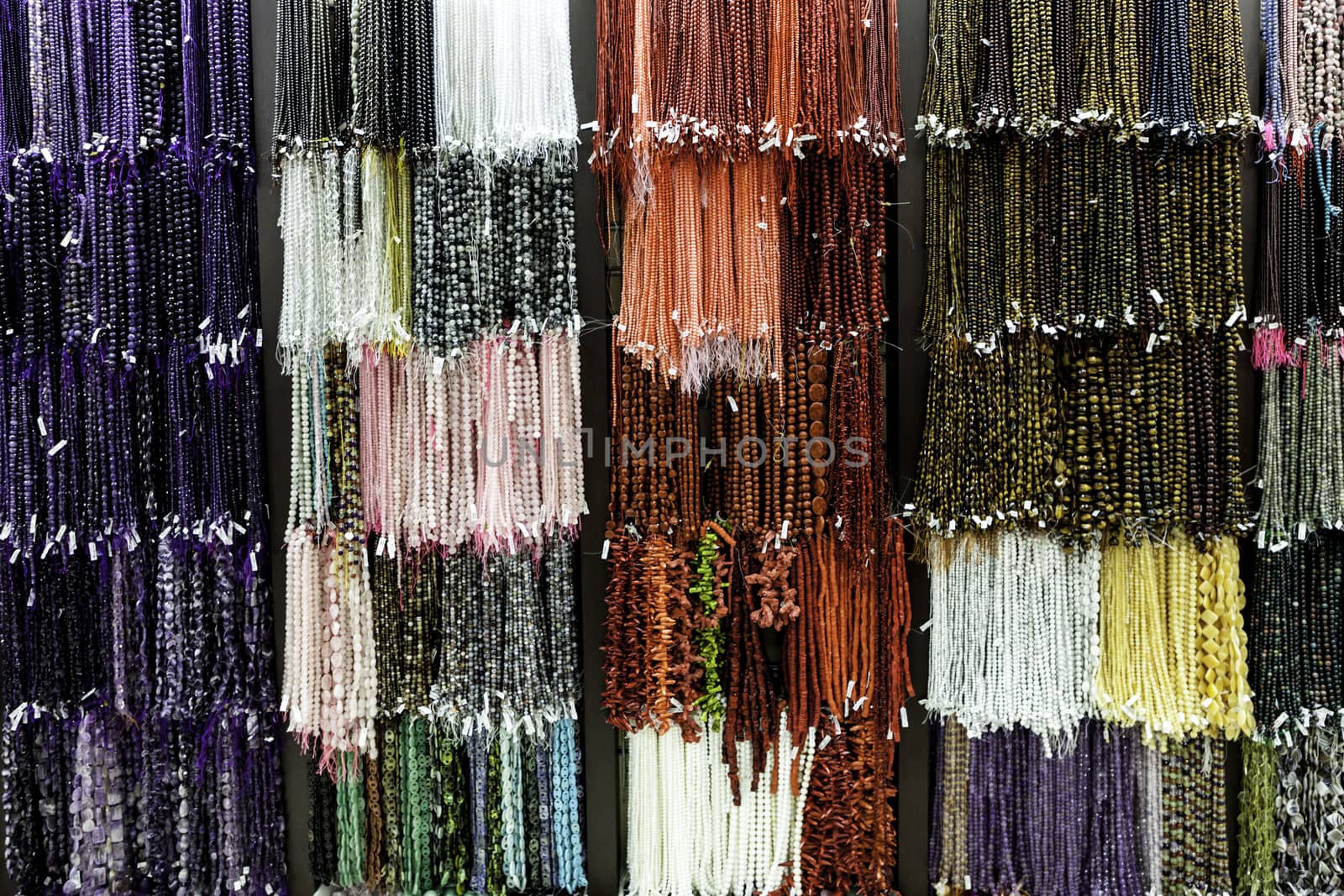 Colorful necklaces hanging on a wall