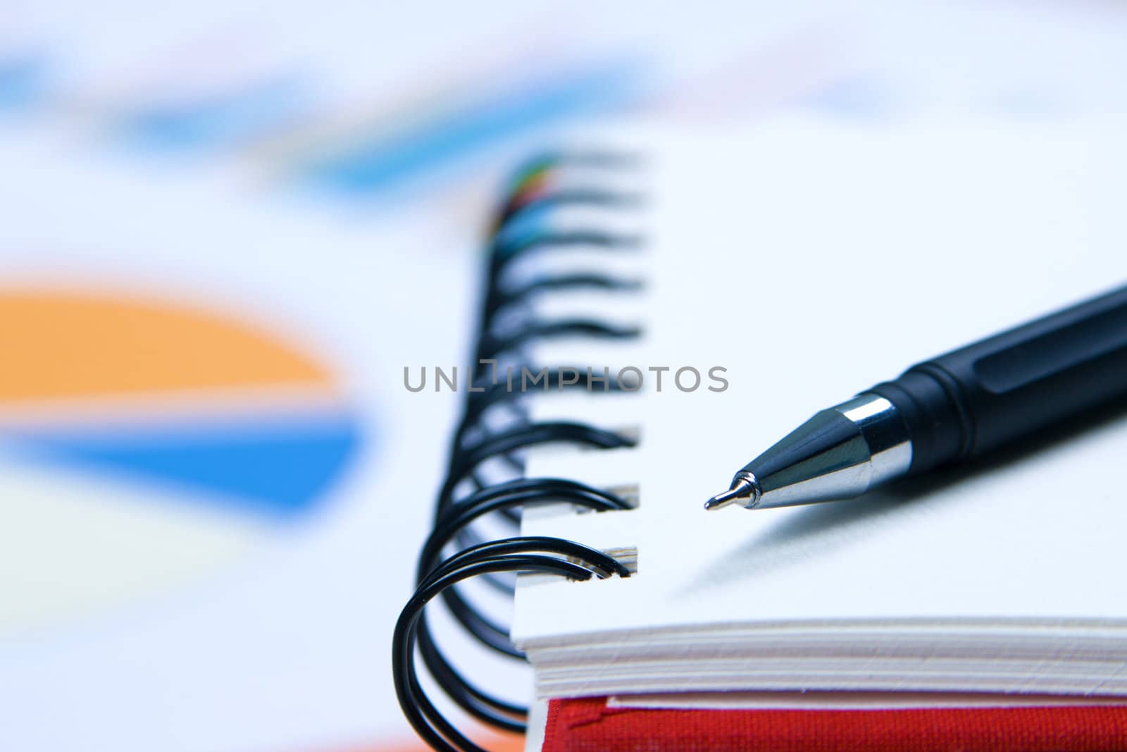 Close-up photo of a notebook and pen by Gdolgikh