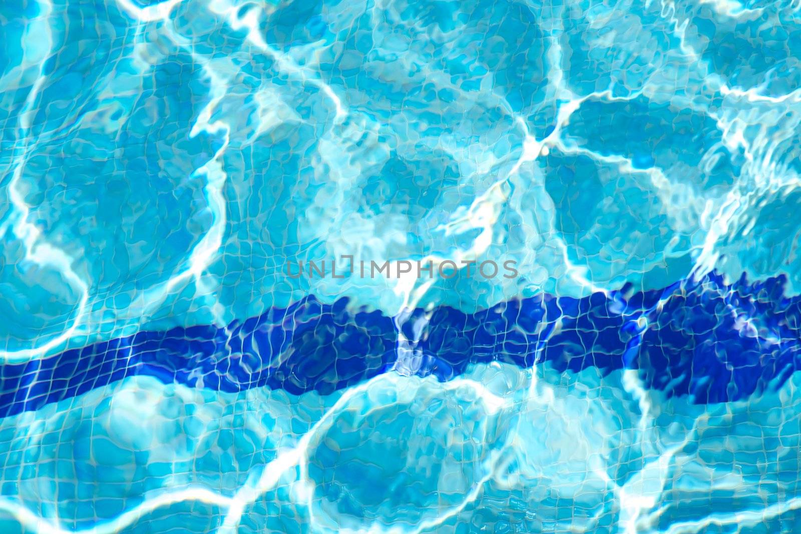 bottom of swimming pool with blue transparent water