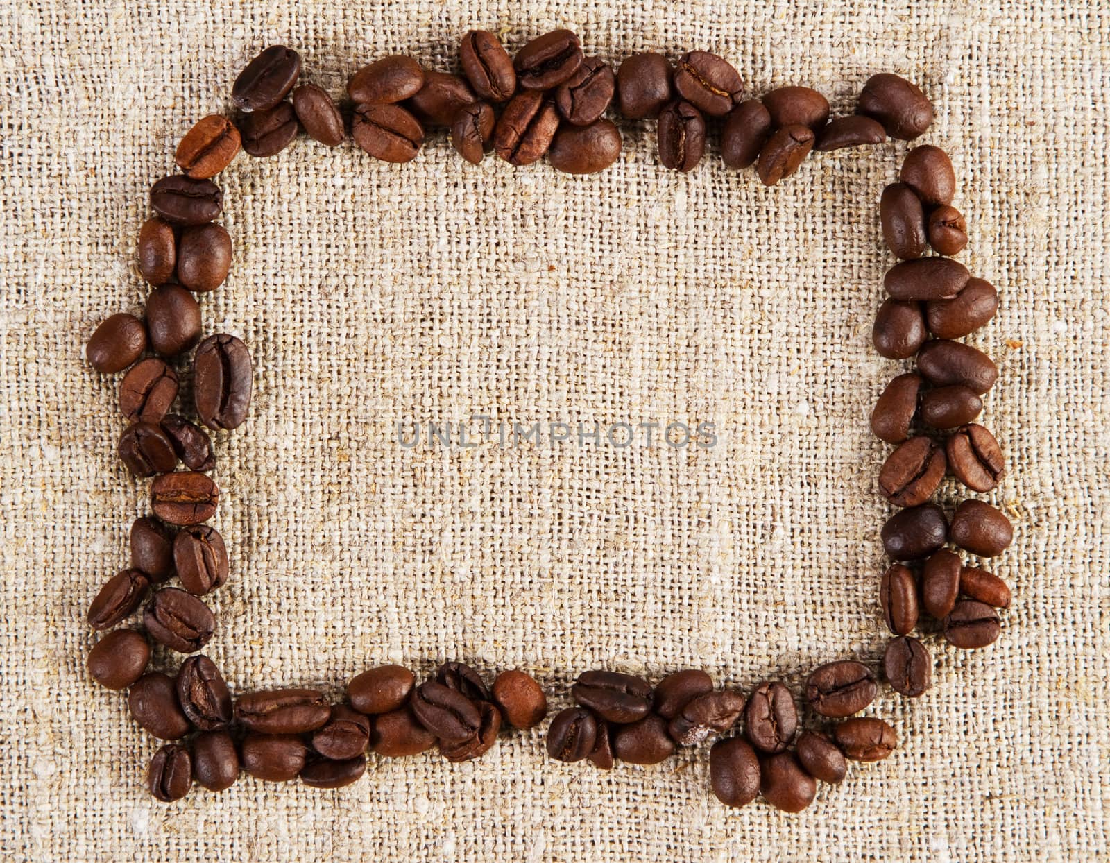 Frame of coffee beans on a sacking cloth by Gdolgikh