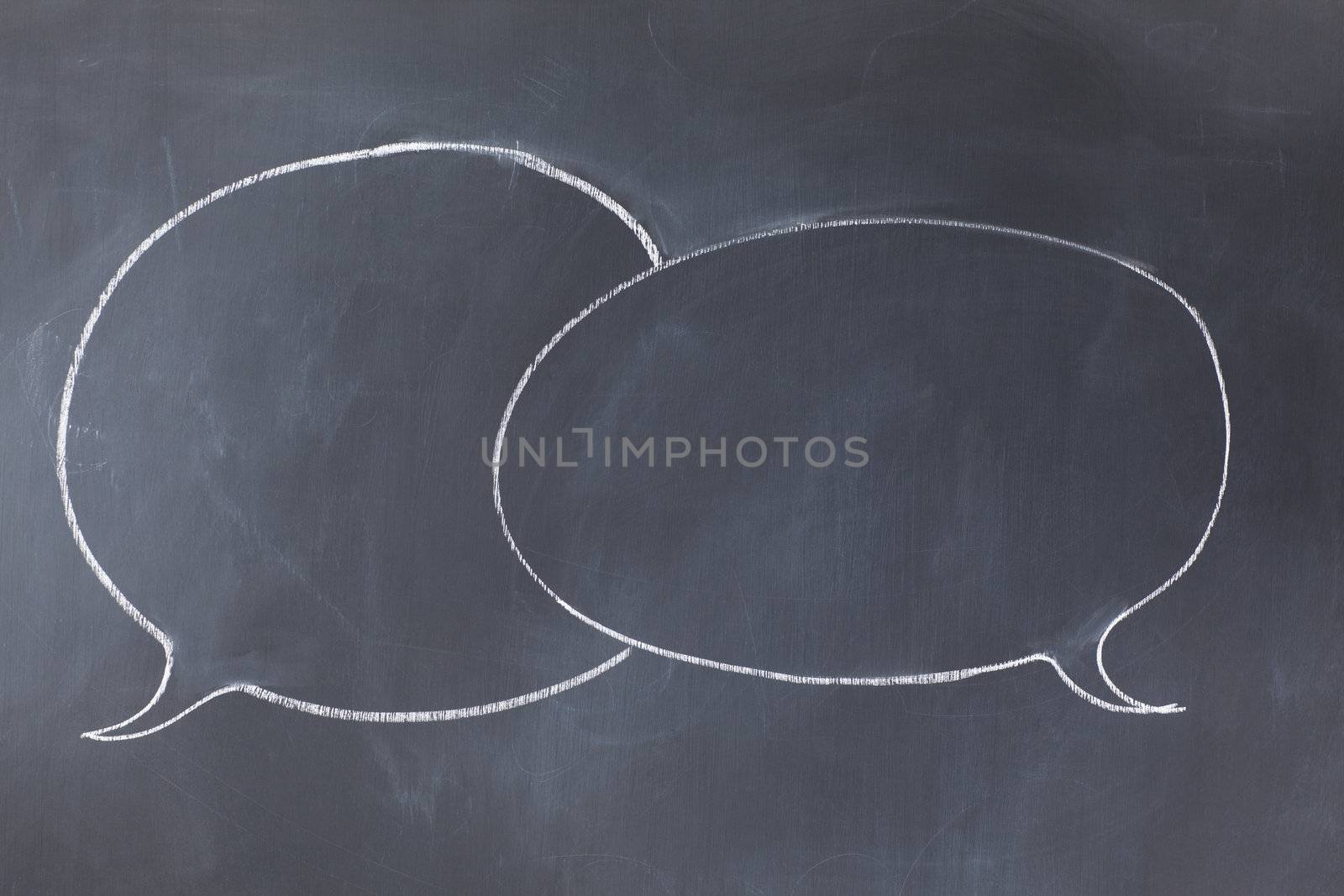Empty circle comic strips balloons on a blackboard