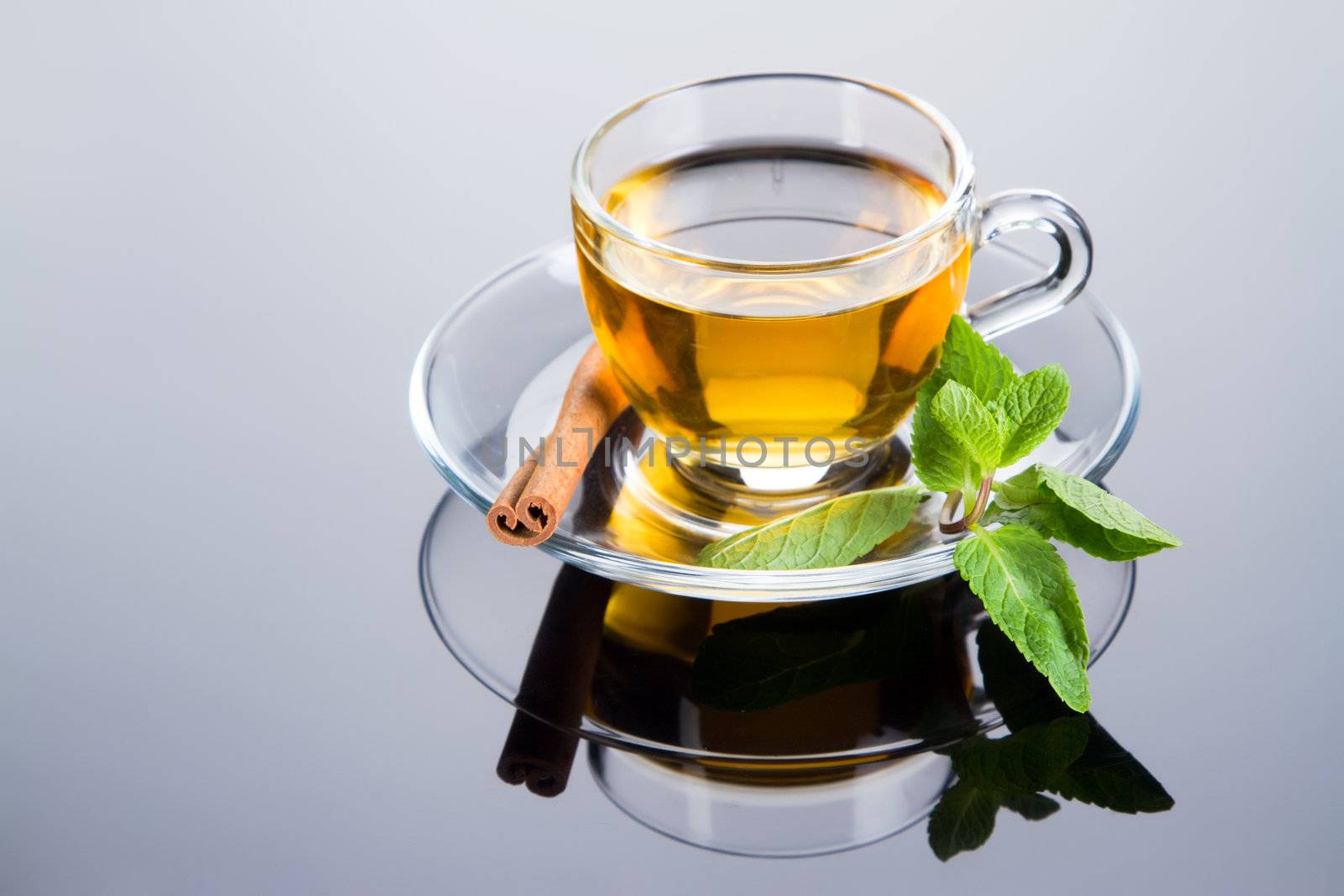 Tea cup with fresh mint leaves, closeup photo