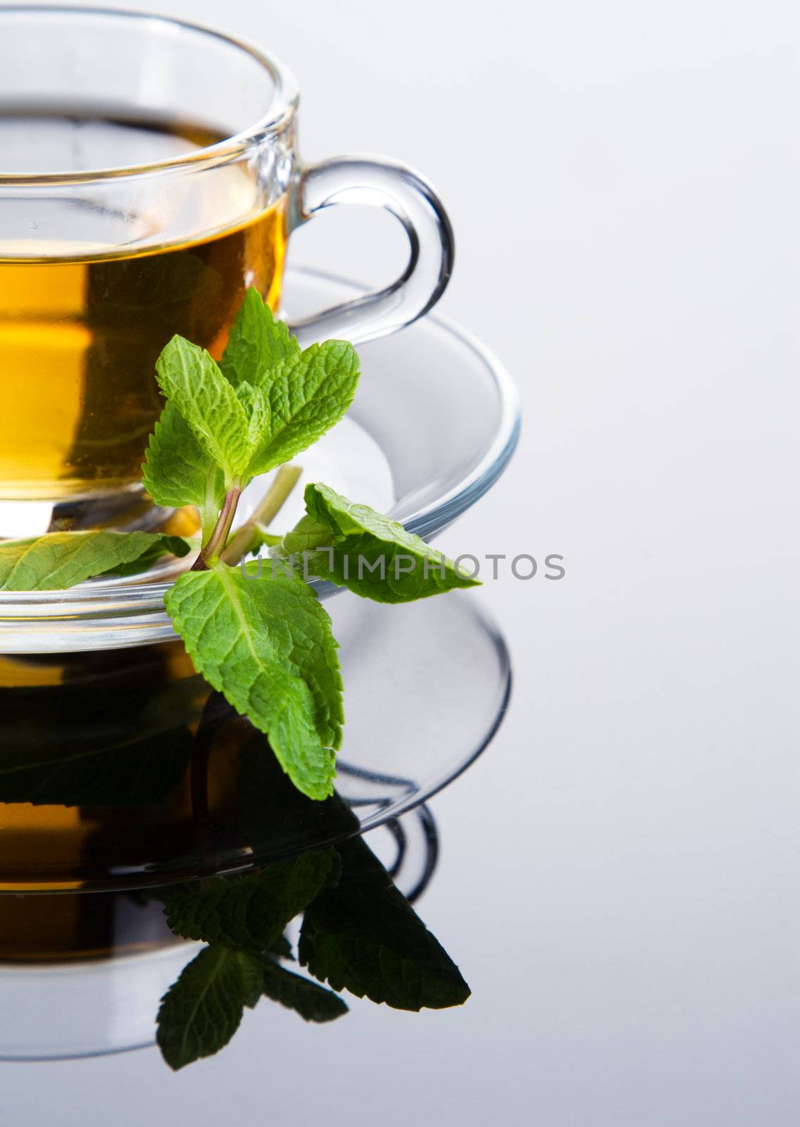 Tea cup with fresh mint leaves, closeup photo