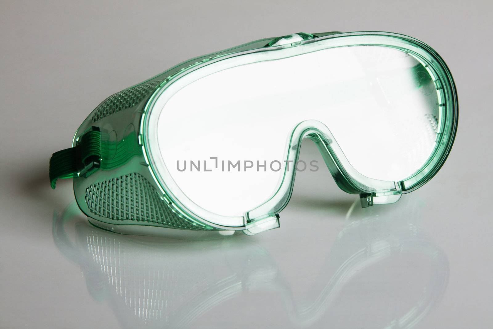 Safety glasses on gray background 
