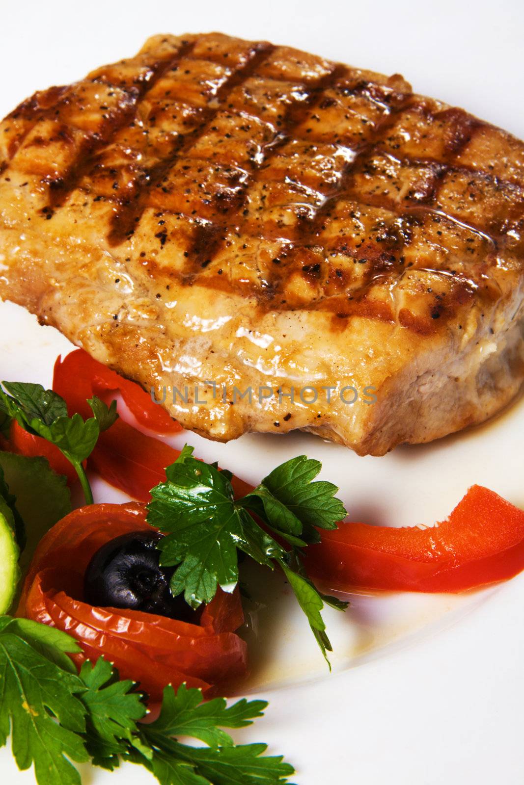 Delicious steak with vegetables close up photo