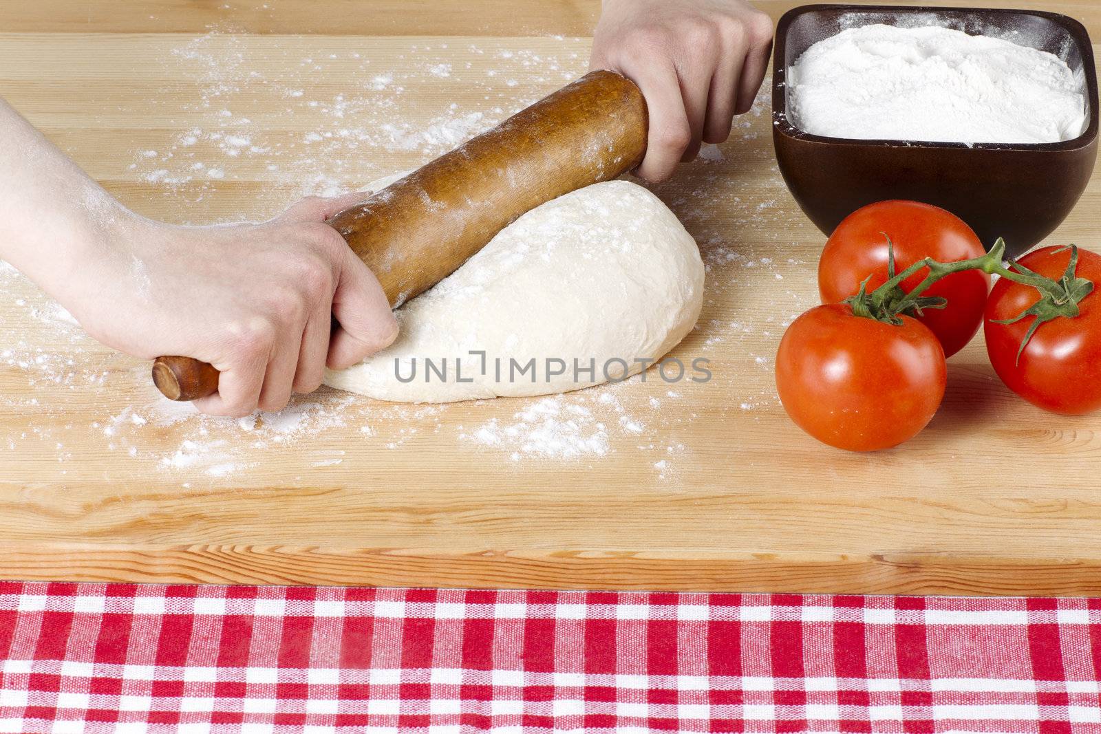 rolling pin kneading on pizza dough by kozzi