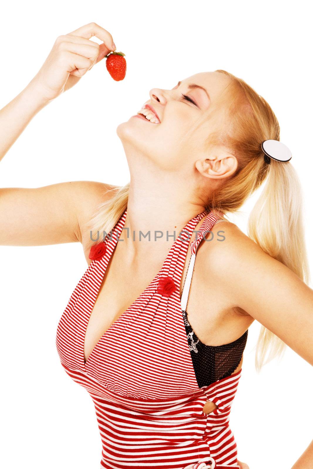 Beautiful girl tasting a strawberry, white background