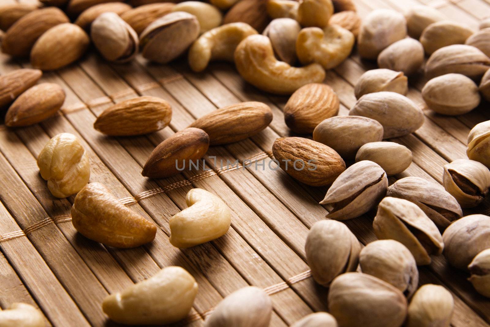 Cashew, almond and pistachios closeup photo by Gdolgikh