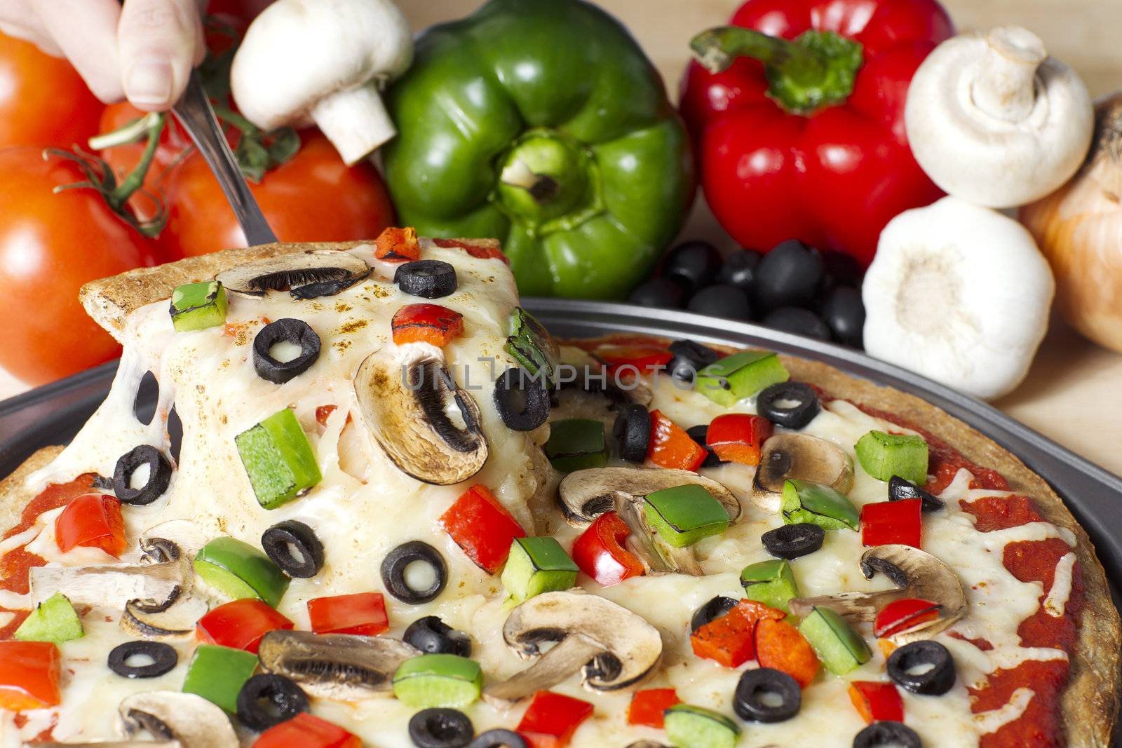Horizontal image of supreme pizza with ingredients on the background