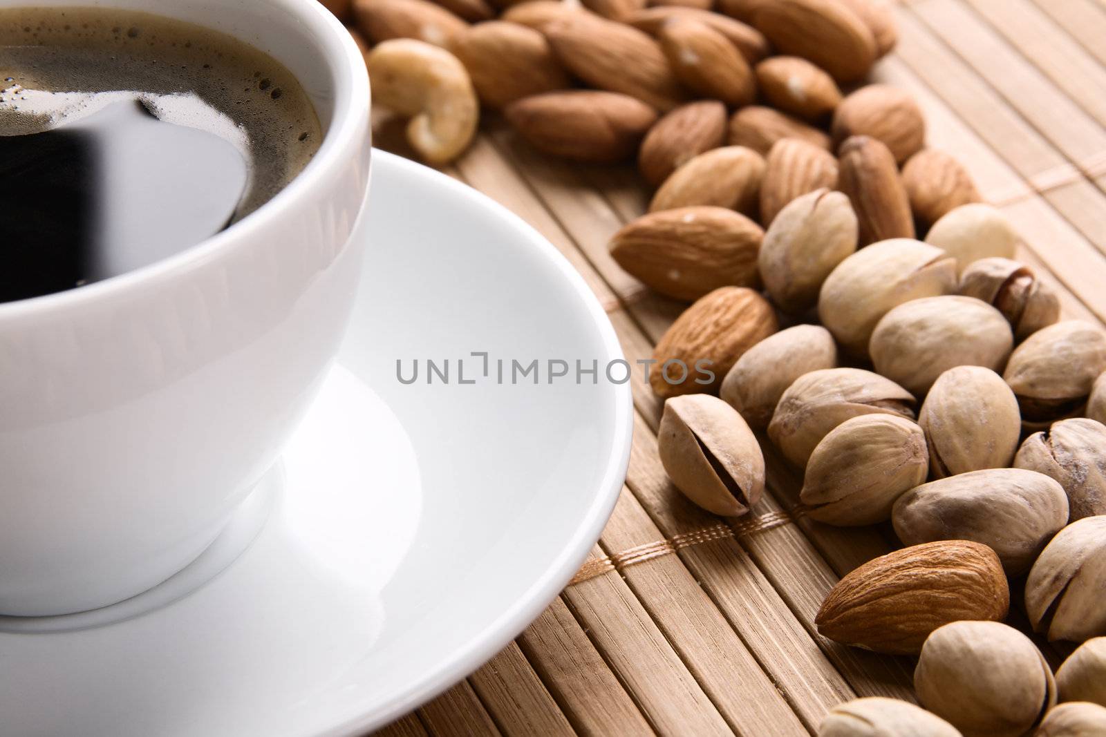 Delicious coffee with nuts on the background 