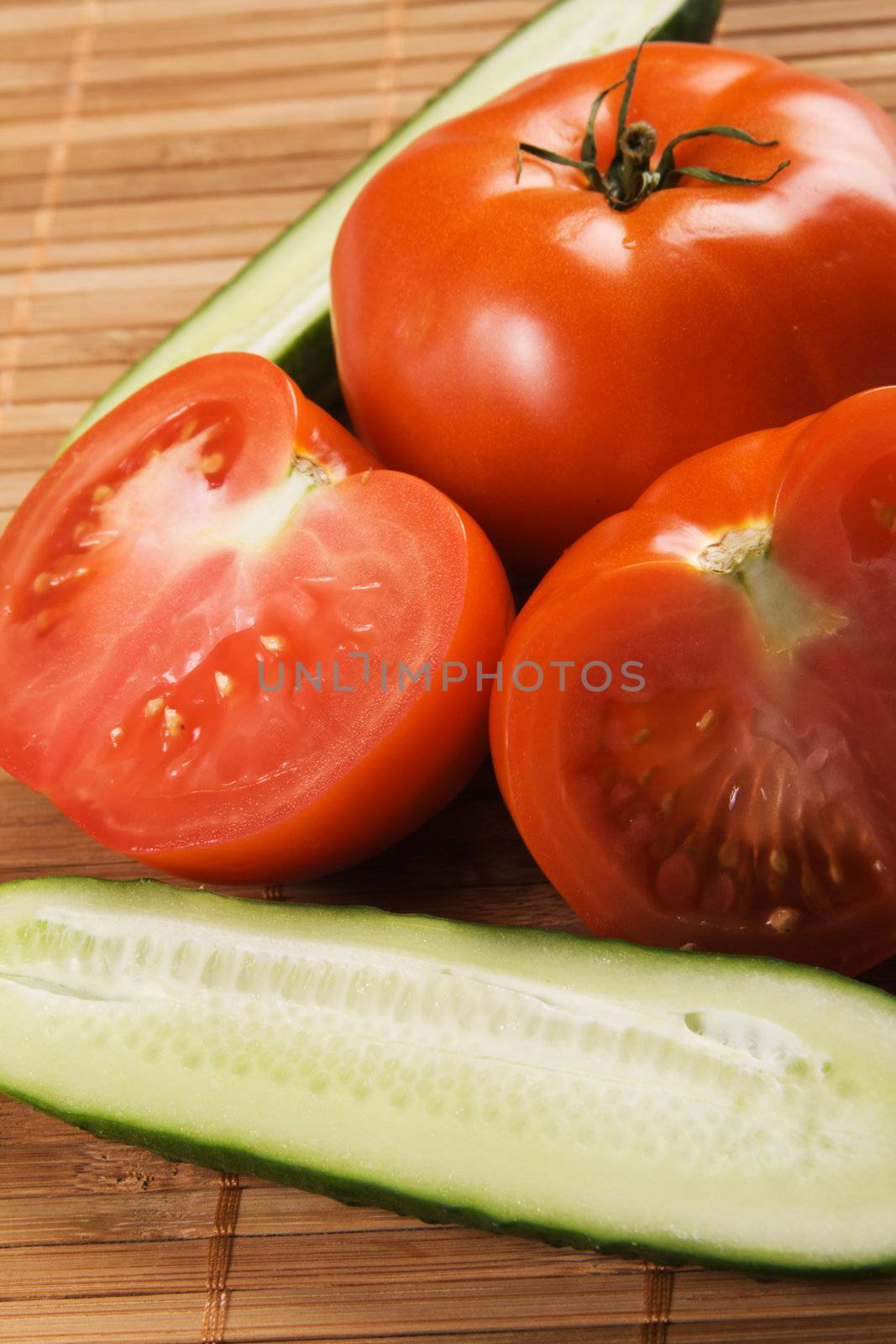 Tomatoes and cucumbers on bamboo pad