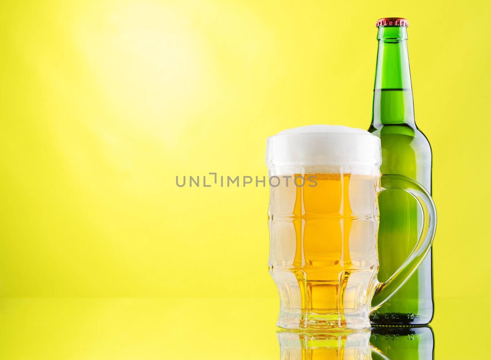 Beer mug and bottles on yellow background by Gdolgikh
