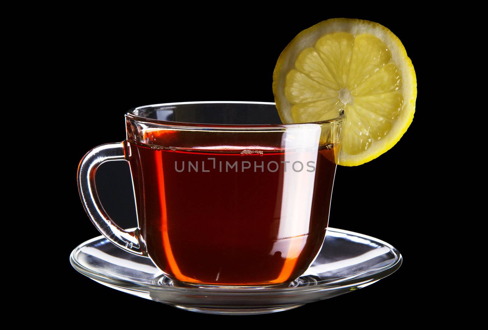 Cup of black tea with lemon isolated on black background