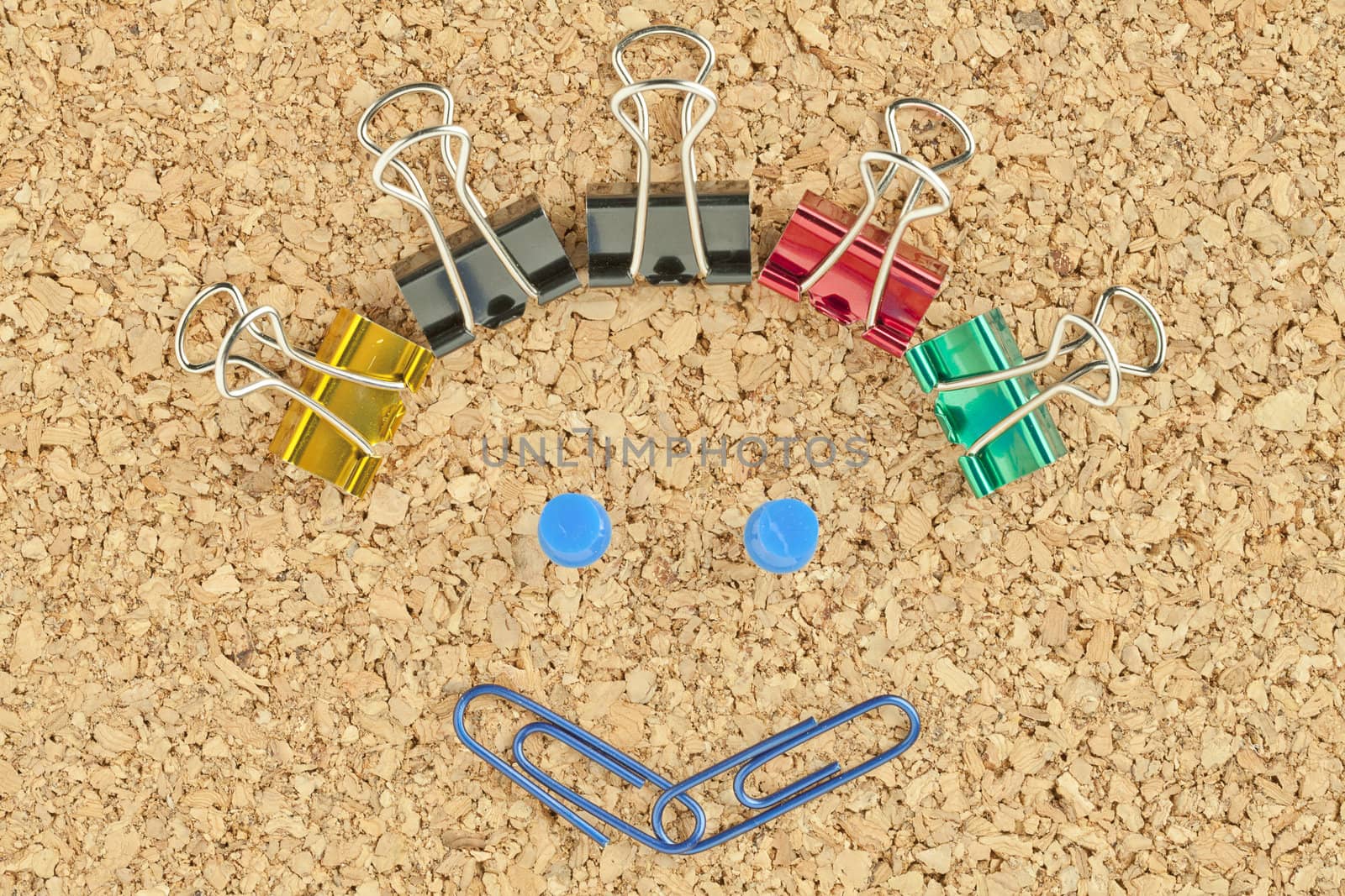 Image of happy face made of colorful clips