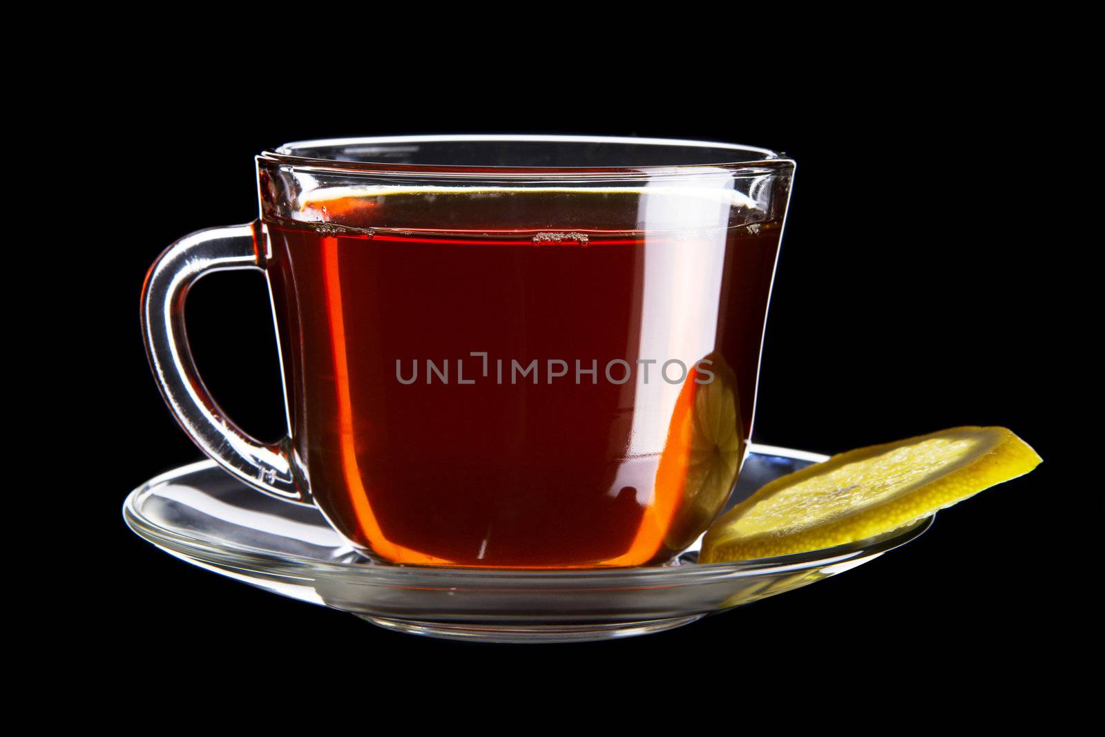 Cup of black tea with lemon isolated on black background