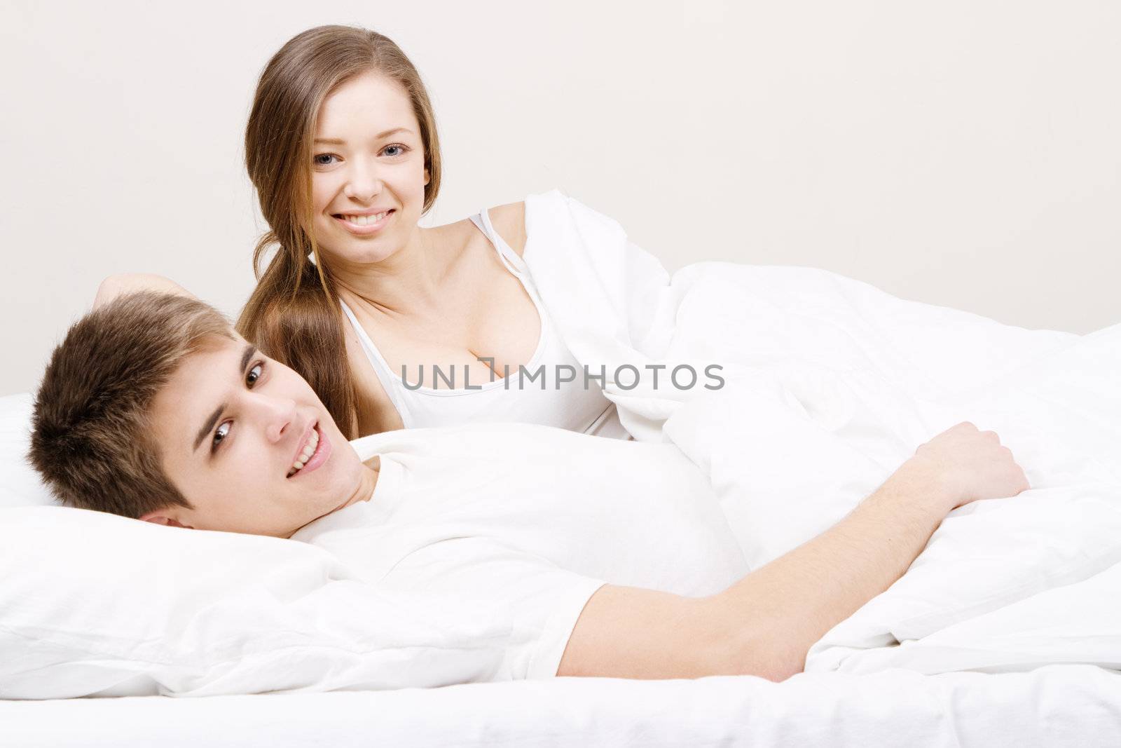 Young beautiful couple in bed