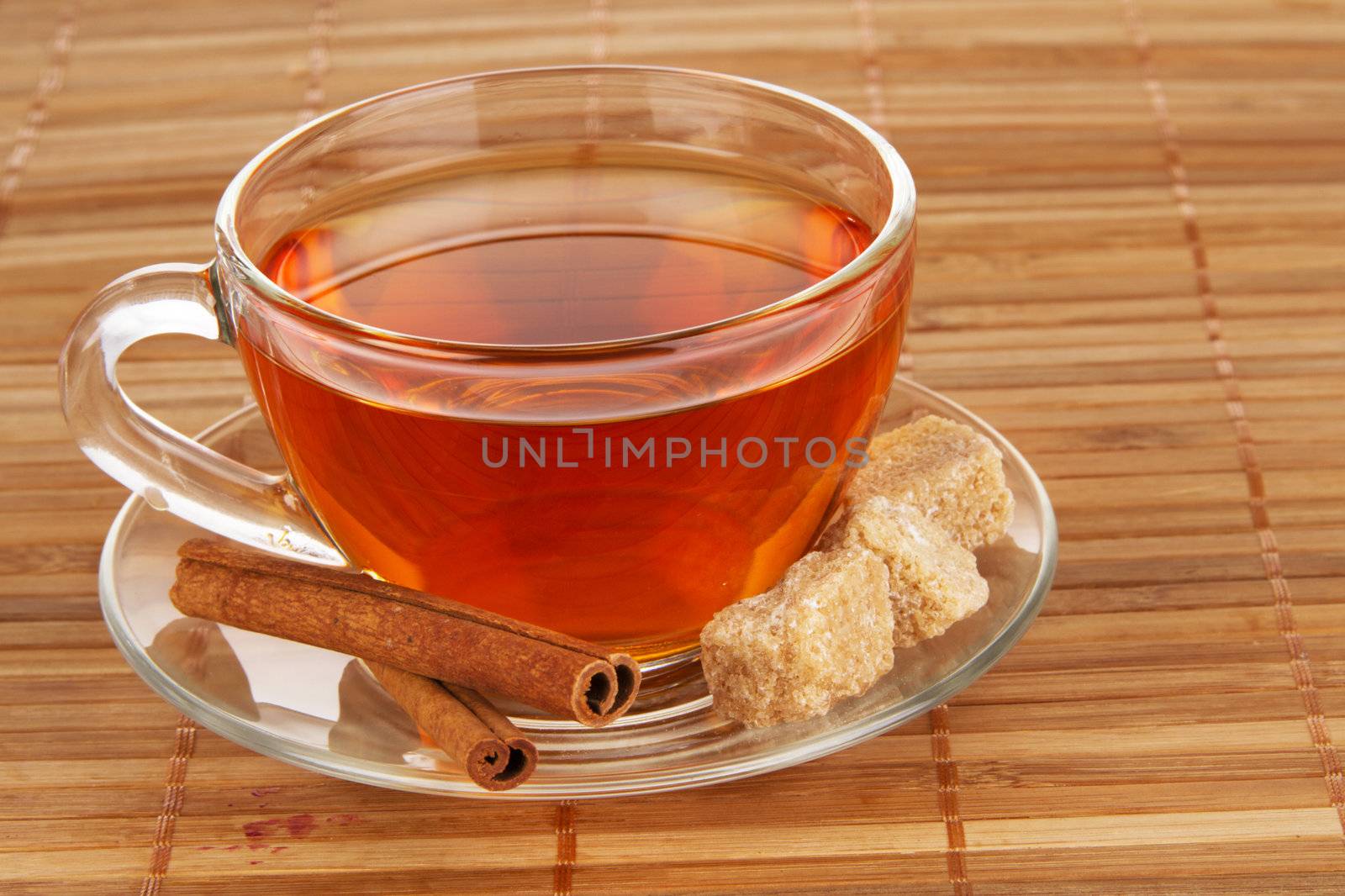 Tea with honey, lemon and cinnamon on bamboo pad