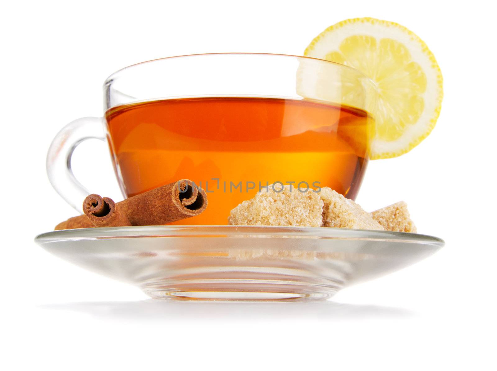 Glass cup of black tea with lemon, cinnamon and sugar, isolated on white