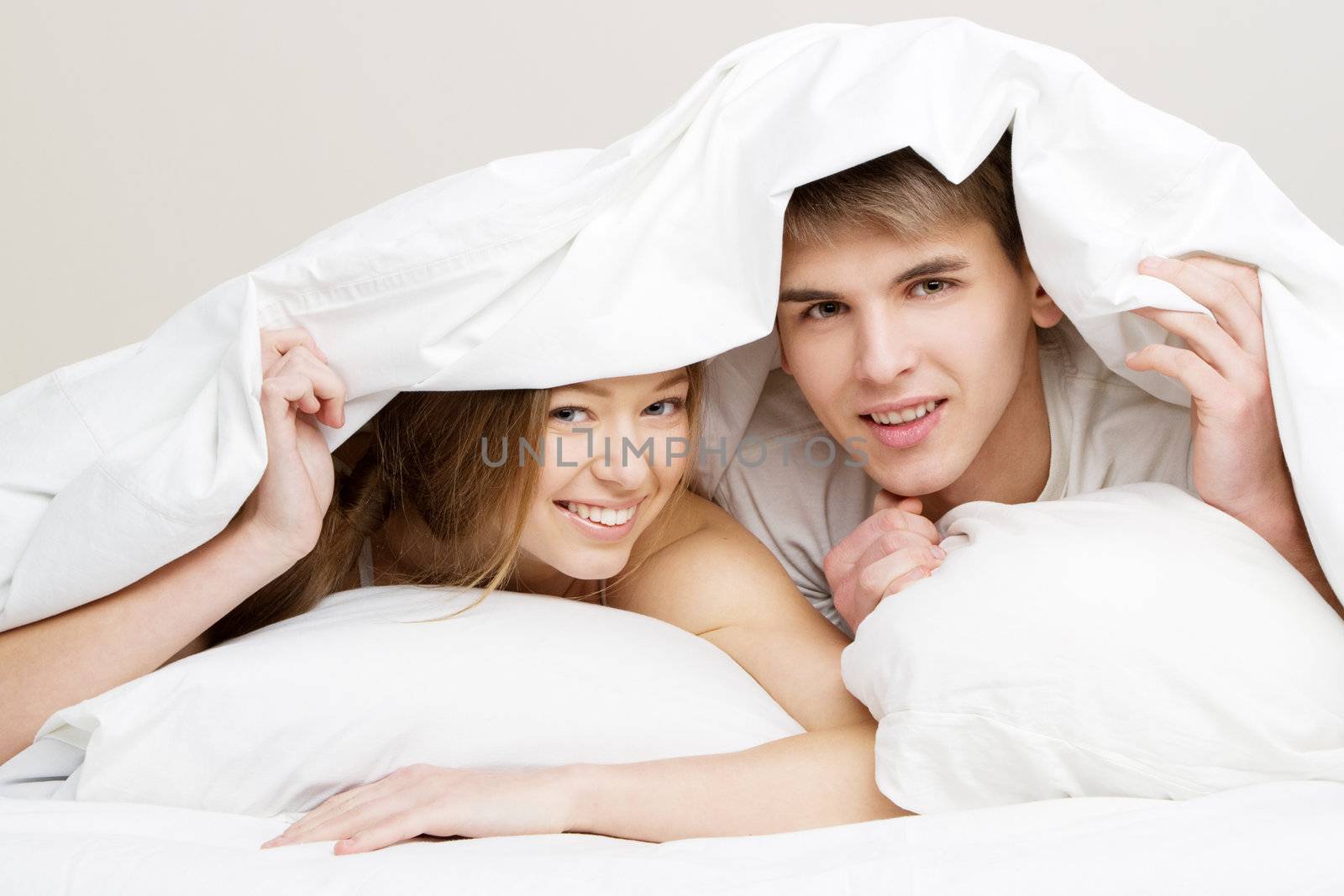 Young beautiful couple in bed