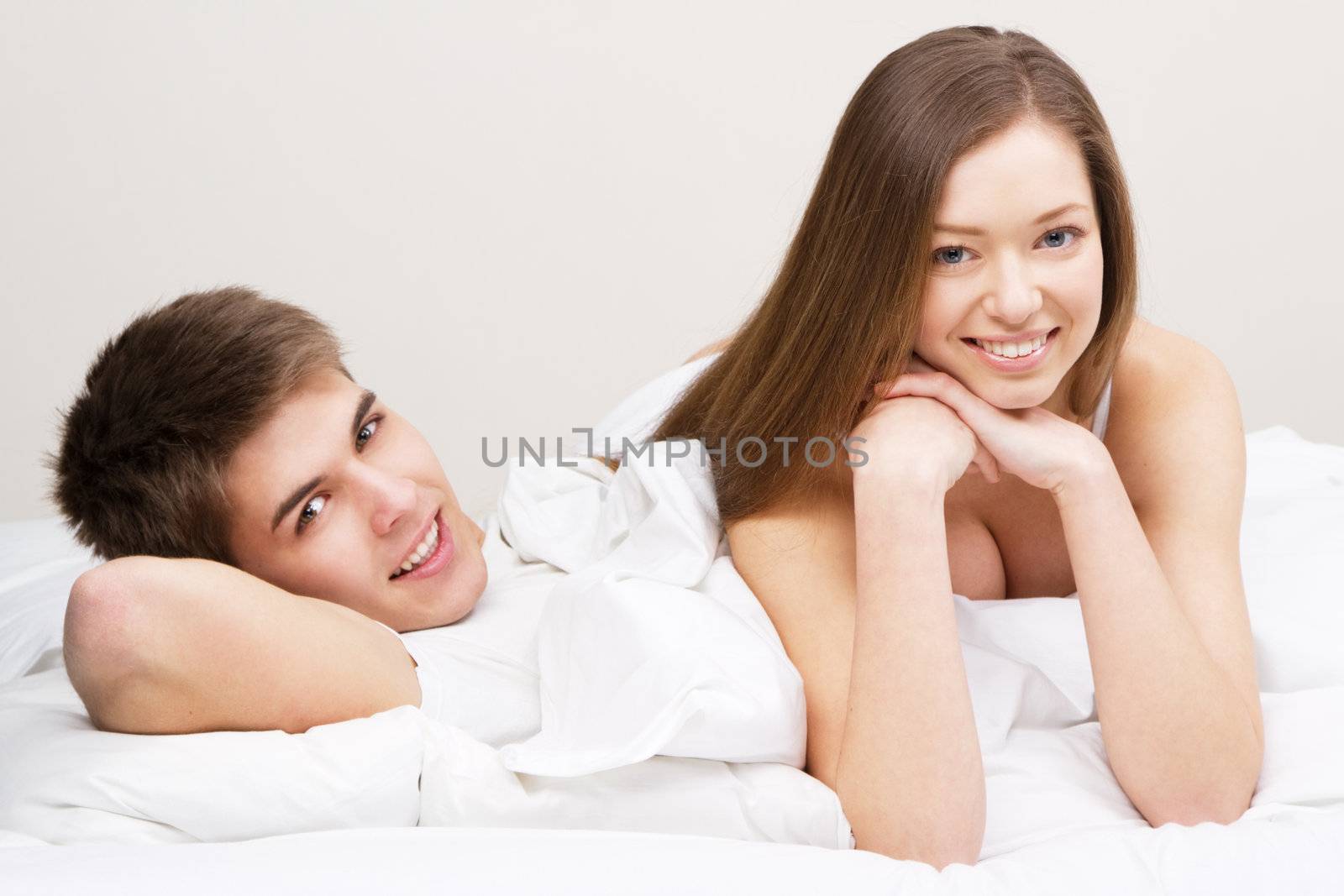 Young beautiful couple in bed