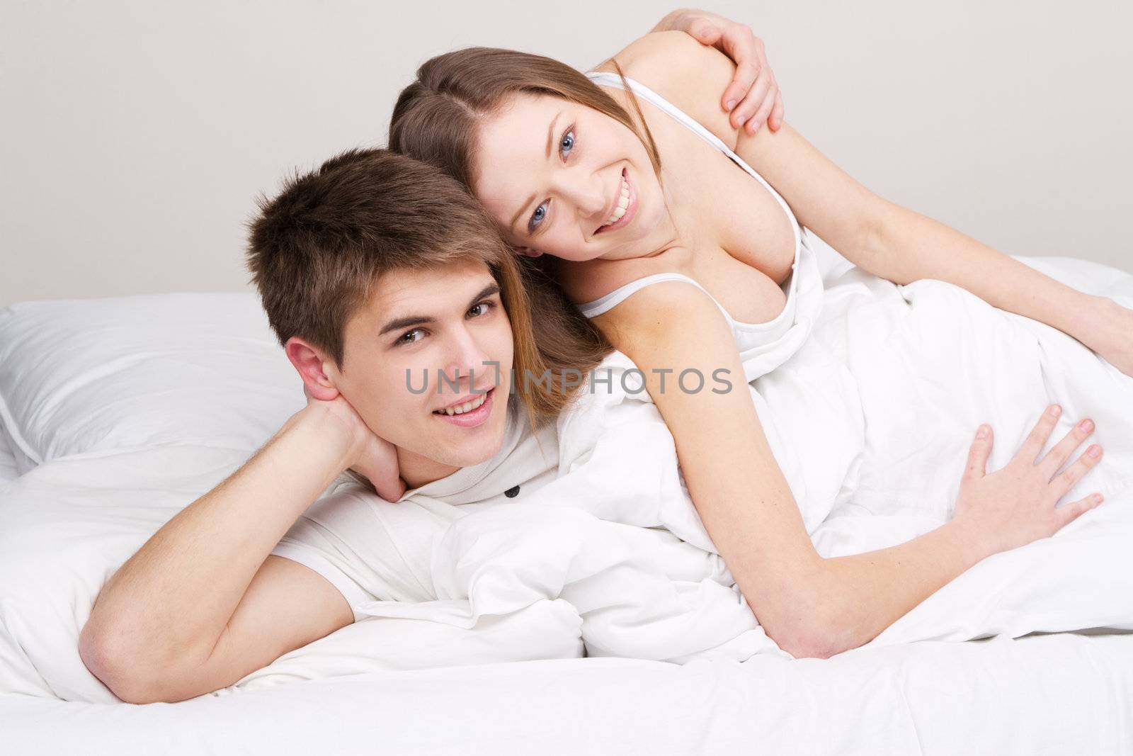 Young beautiful couple in bed