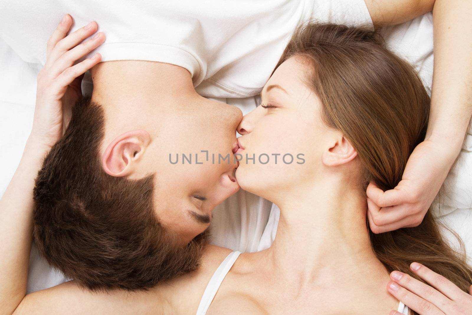 Beautiful young couple in bed, face portrait