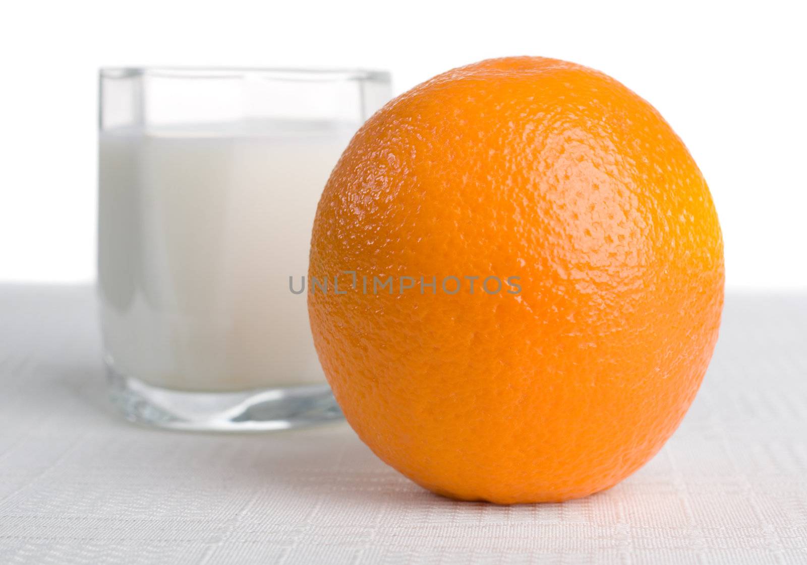Fresh orange with glass of milk on background