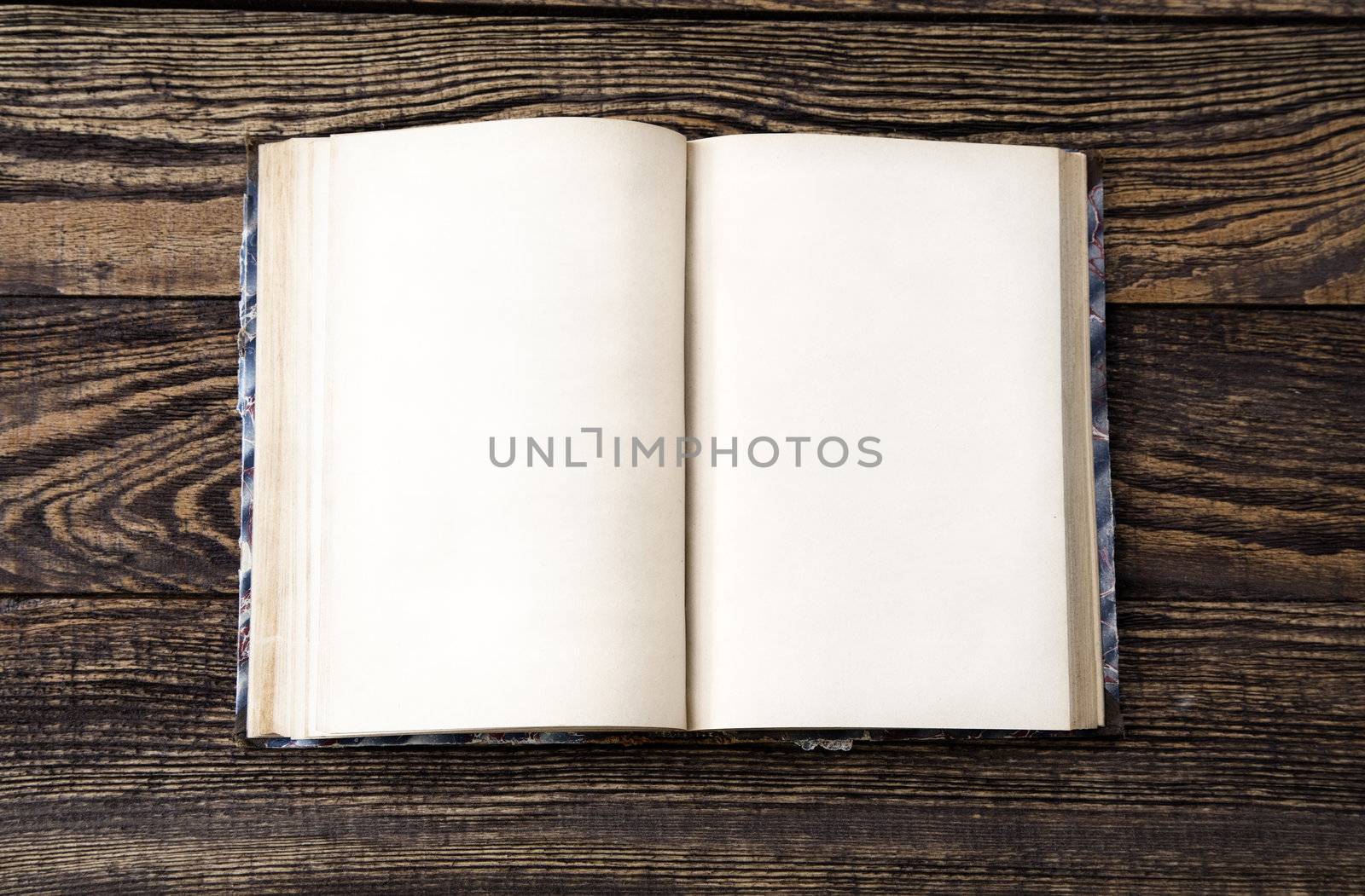 Aged blank book on wooden table, blank pages