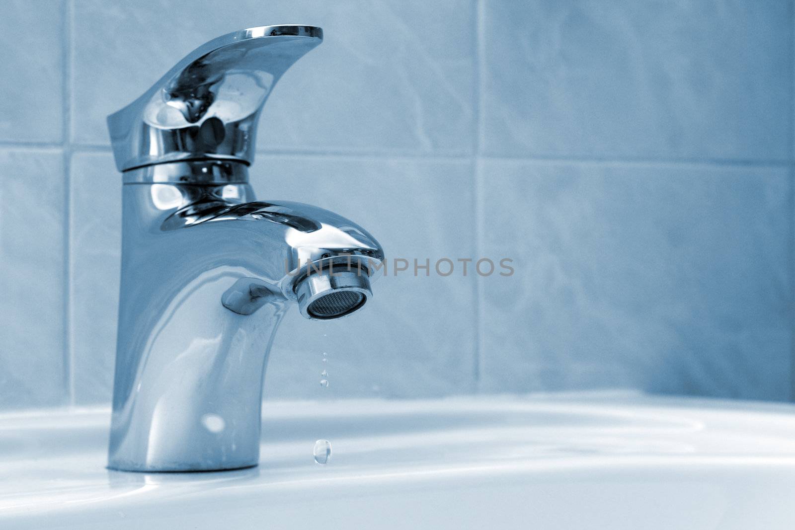 Water dripping from a faucet by Gdolgikh