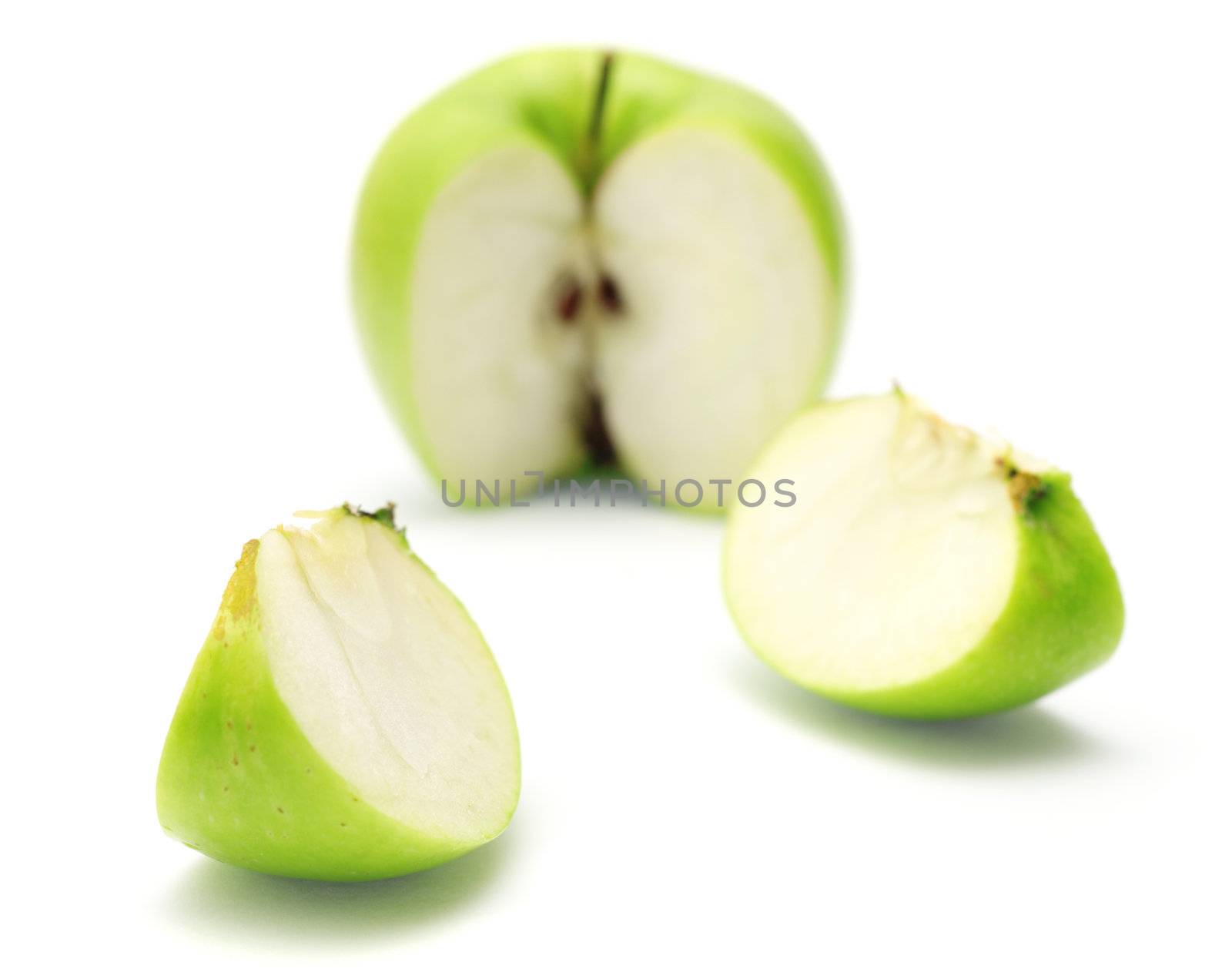 Cut green apple isolated on white background.