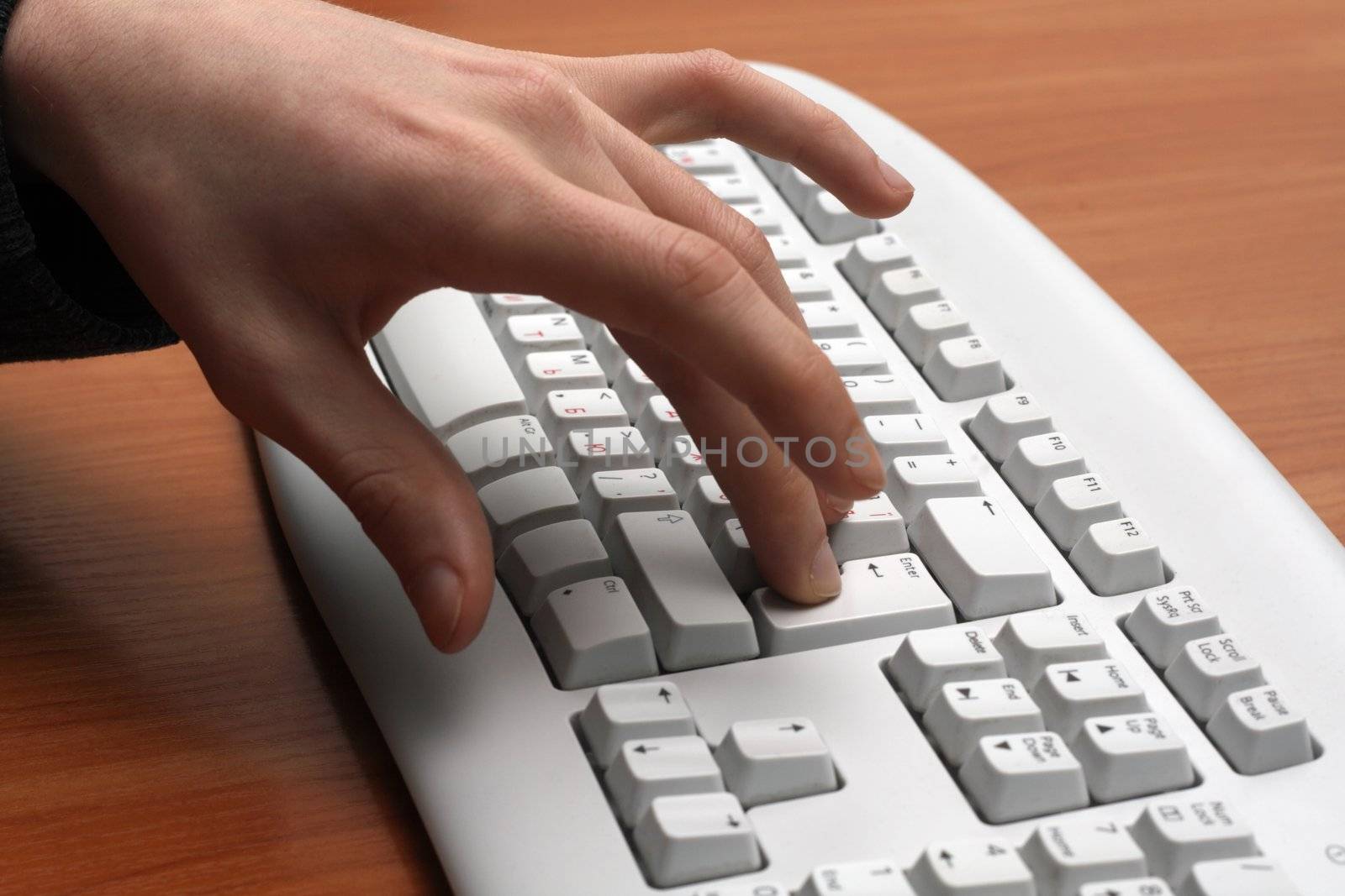 Finger pushing the enter key on keyboard